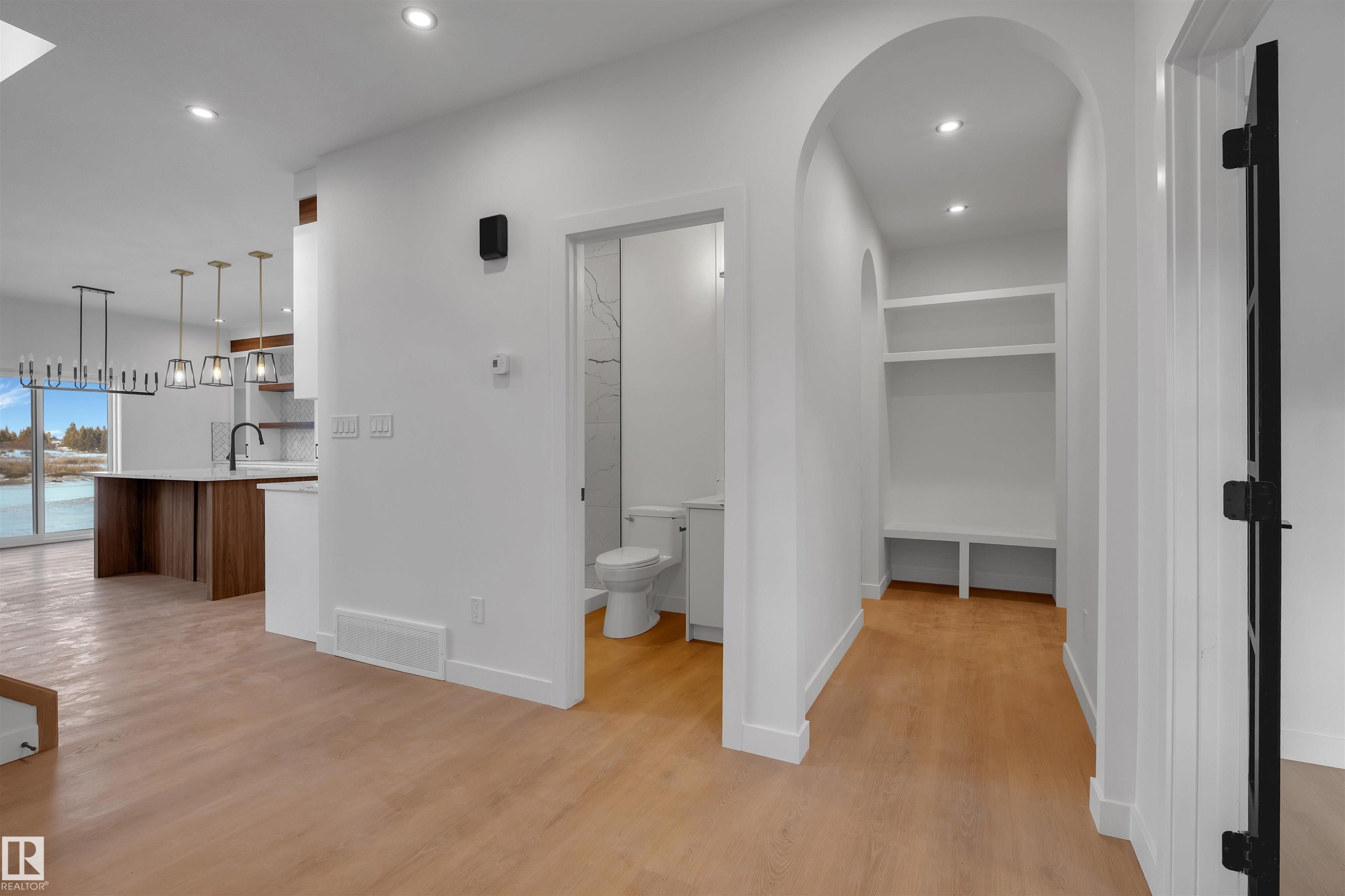 Hallway with arched walkways, light wood-type flooring, and recessed lighting - 34 Grayson Green, Stony Plain, AB - Indoor Photo Showing Other Room