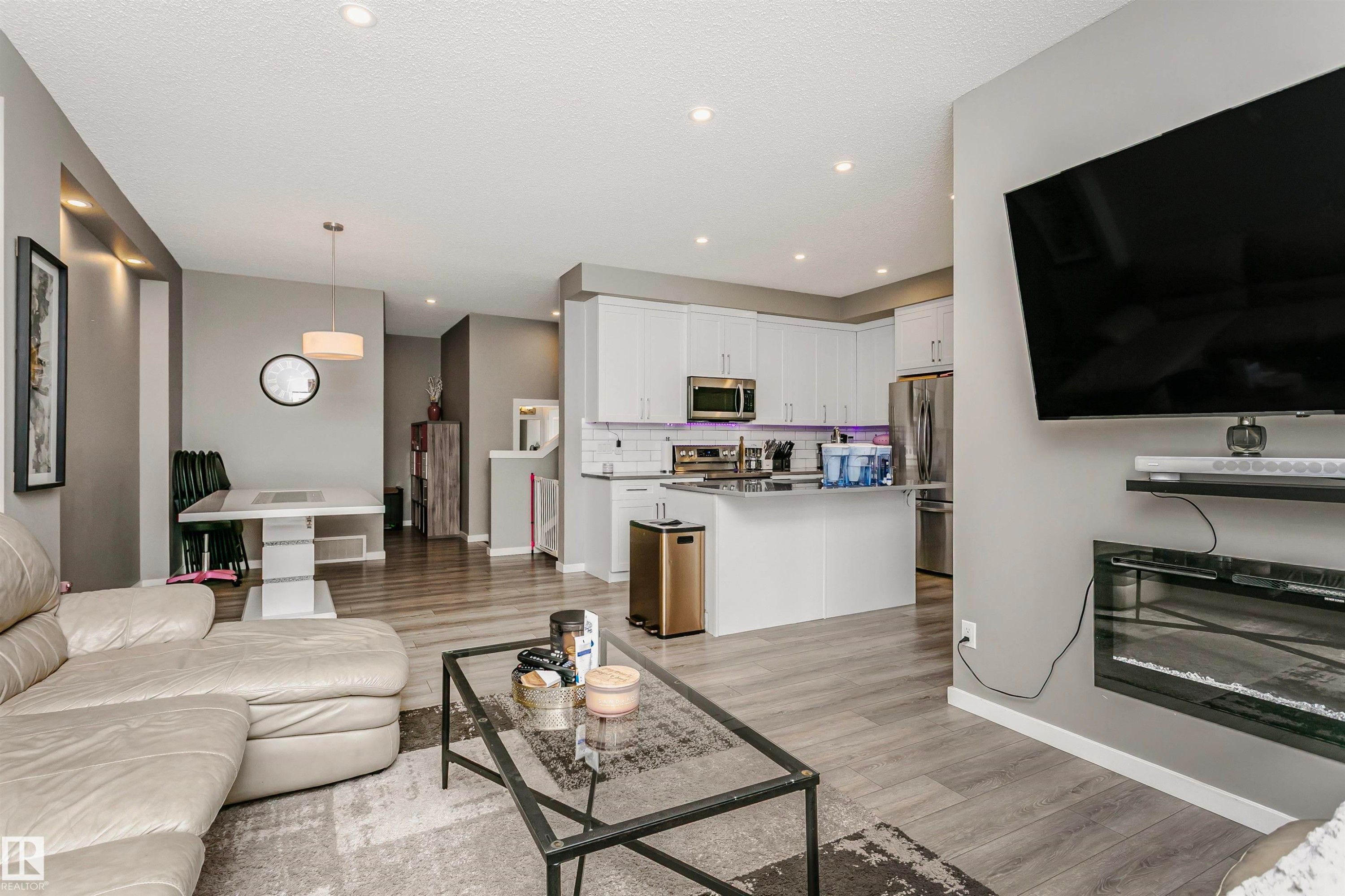 Living area with light wood finished floors, recessed lighting, and a textured ceiling - 7322 Chivers Crescent, Edmonton, AB - Indoor Photo Showing Living Room