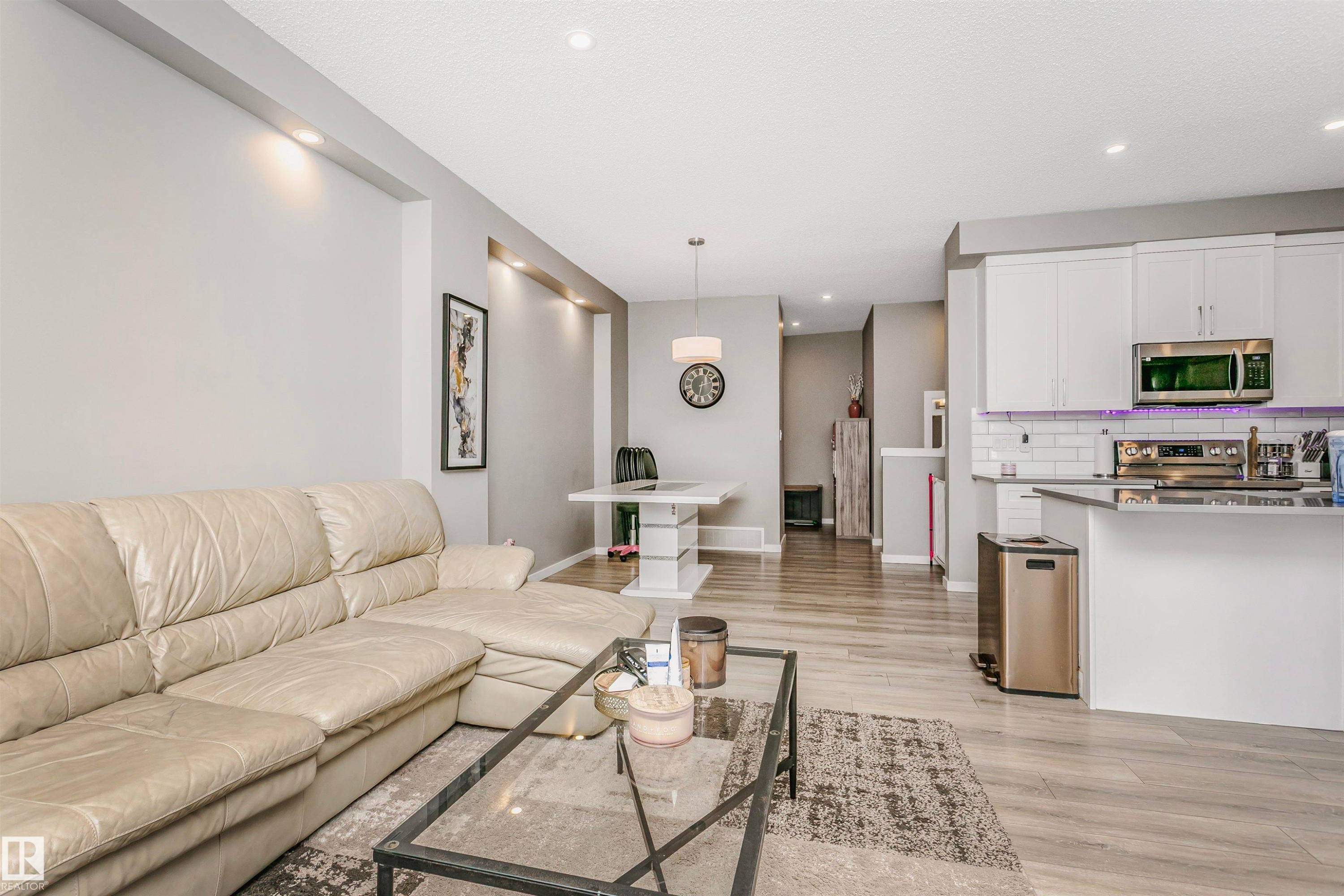 Living room featuring light wood finished floors and recessed lighting - 7322 Chivers Crescent, Edmonton, AB - Indoor