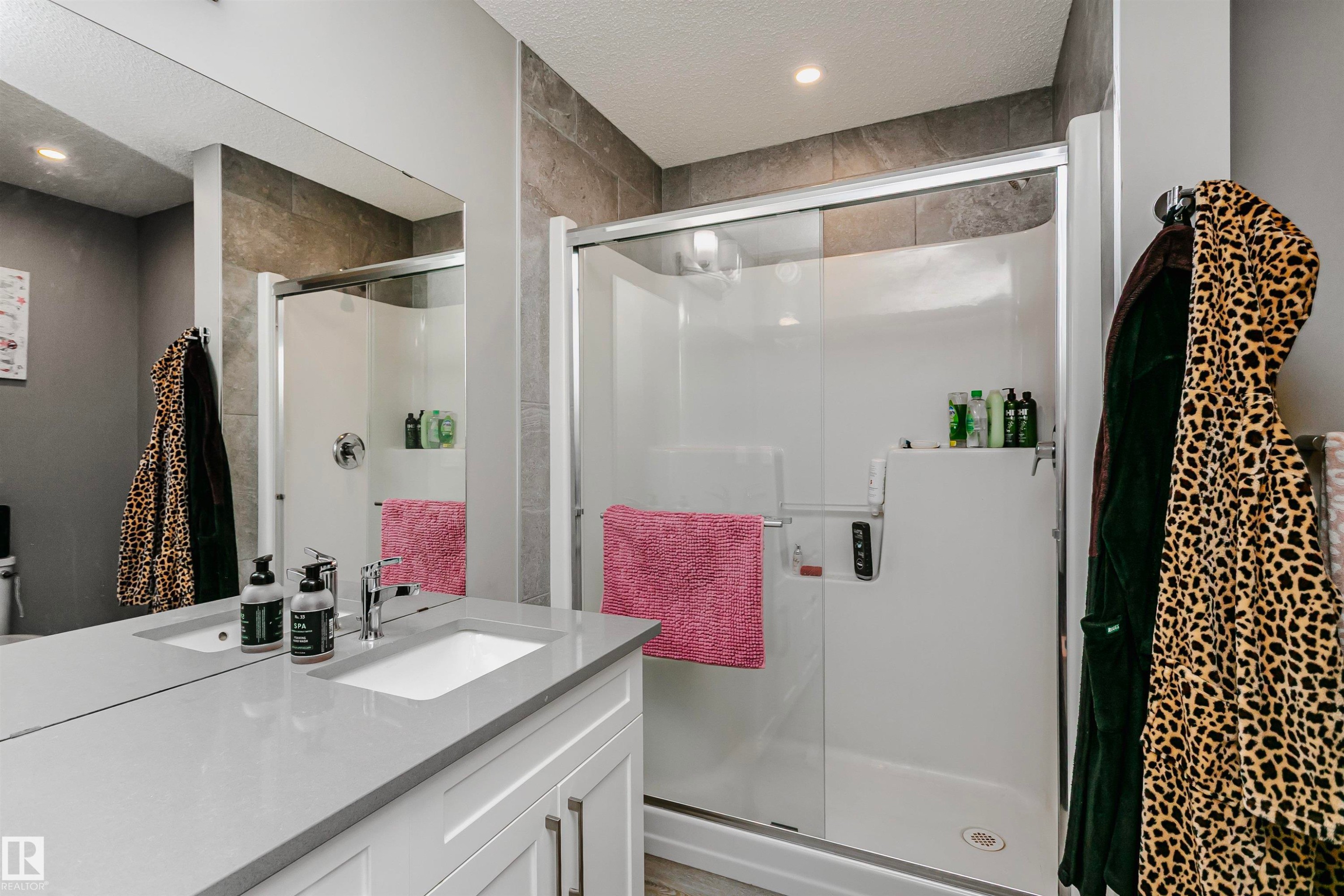 Full bath featuring vanity, a stall shower, a textured ceiling, and recessed lighting - 7322 Chivers Crescent, Edmonton, AB - Indoor Photo Showing Bathroom