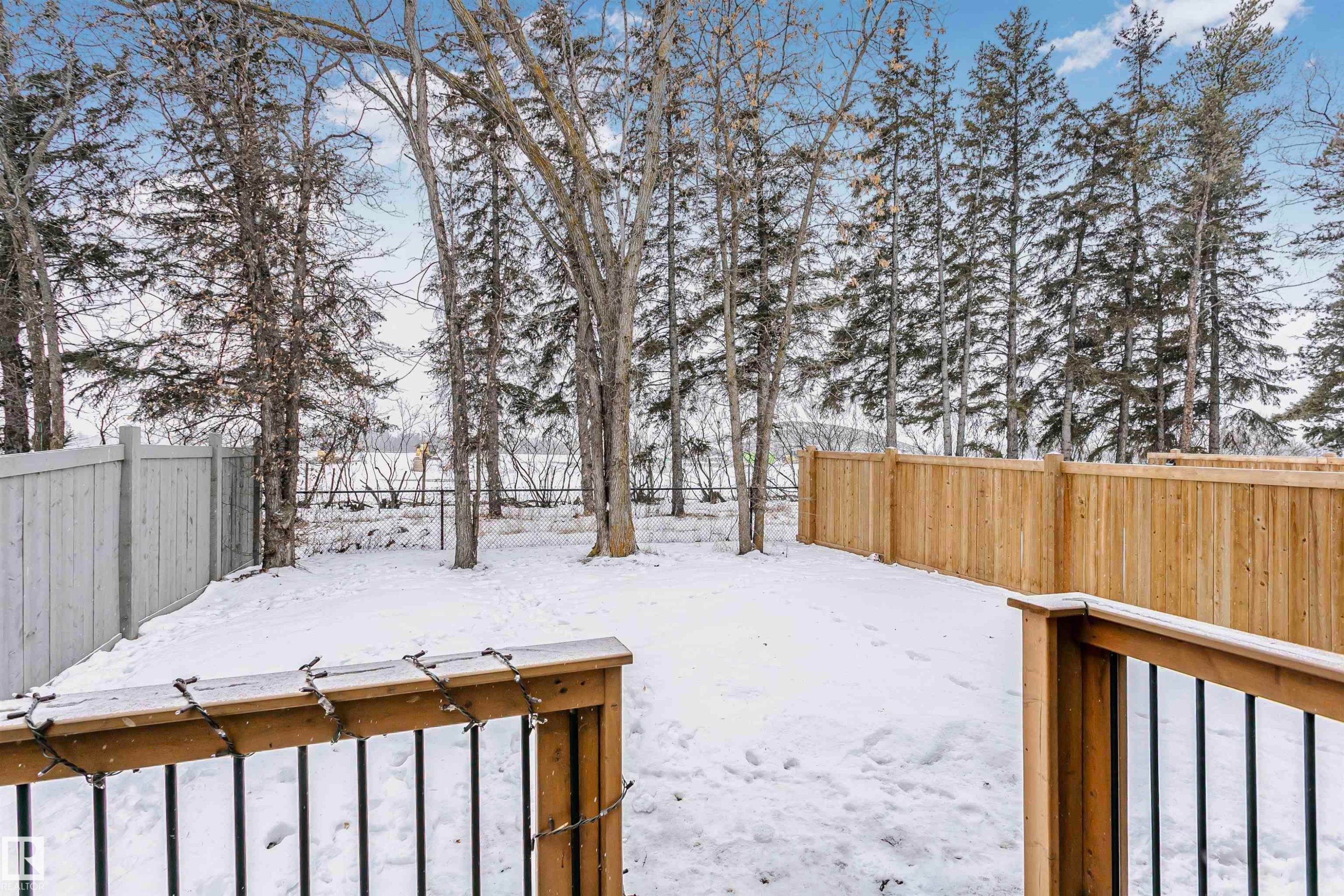 Snowy yard featuring a fenced backyard - 7322 Chivers Crescent, Edmonton, AB - Outdoor