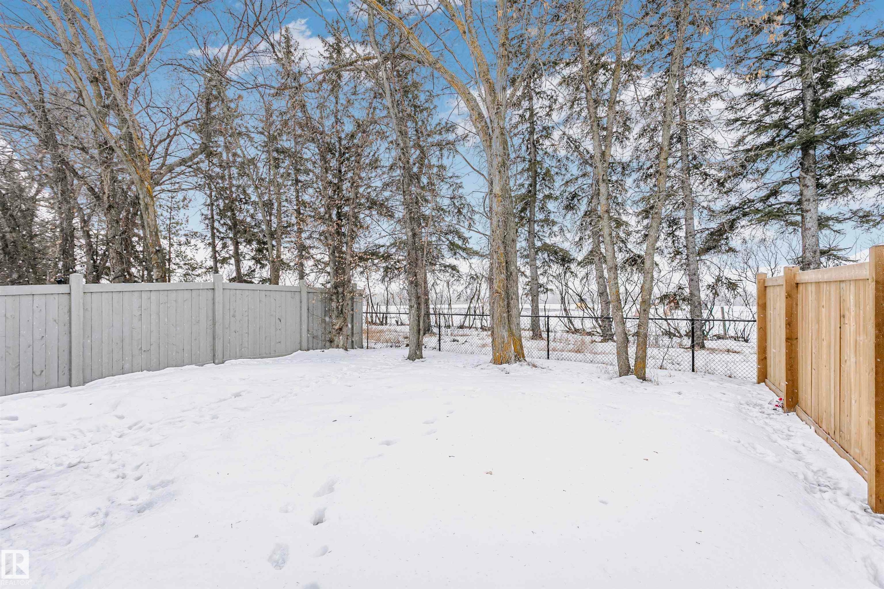 Snowy yard featuring a fenced backyard - 7322 Chivers Crescent, Edmonton, AB - Outdoor