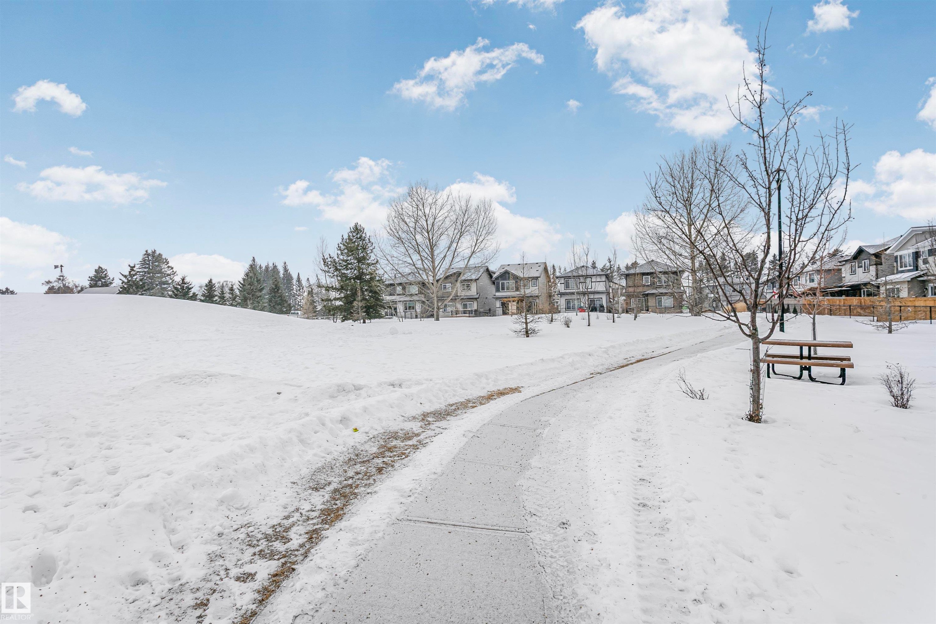 View of asphalt road featuring a residential view - 7322 Chivers Crescent, Edmonton, AB - Outdoor With View