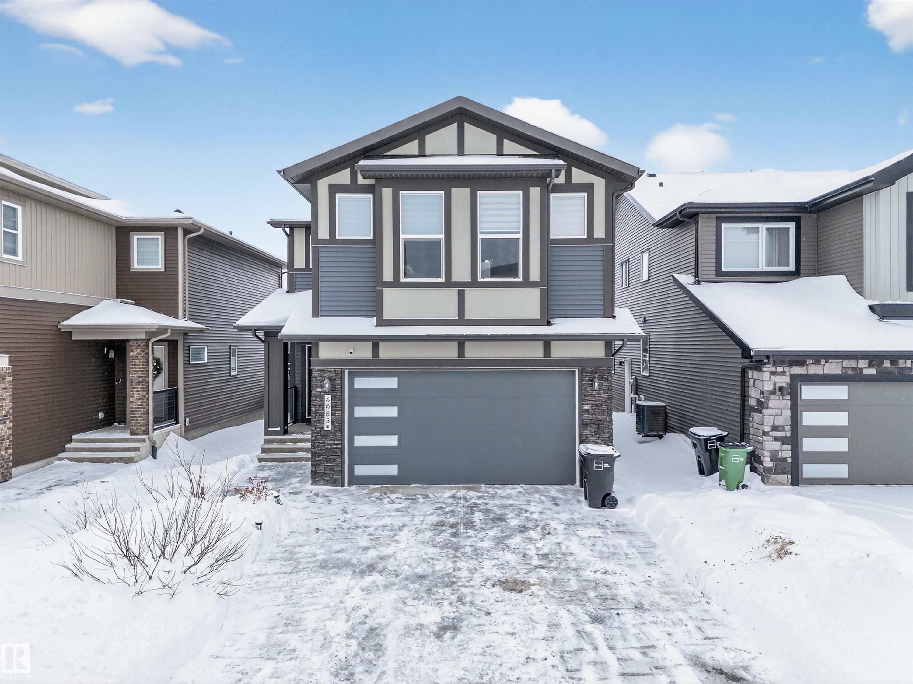 Contemporary home featuring an attached garage and stone siding - 6085 King Landing, Edmonton, AB - Outdoor With Facade