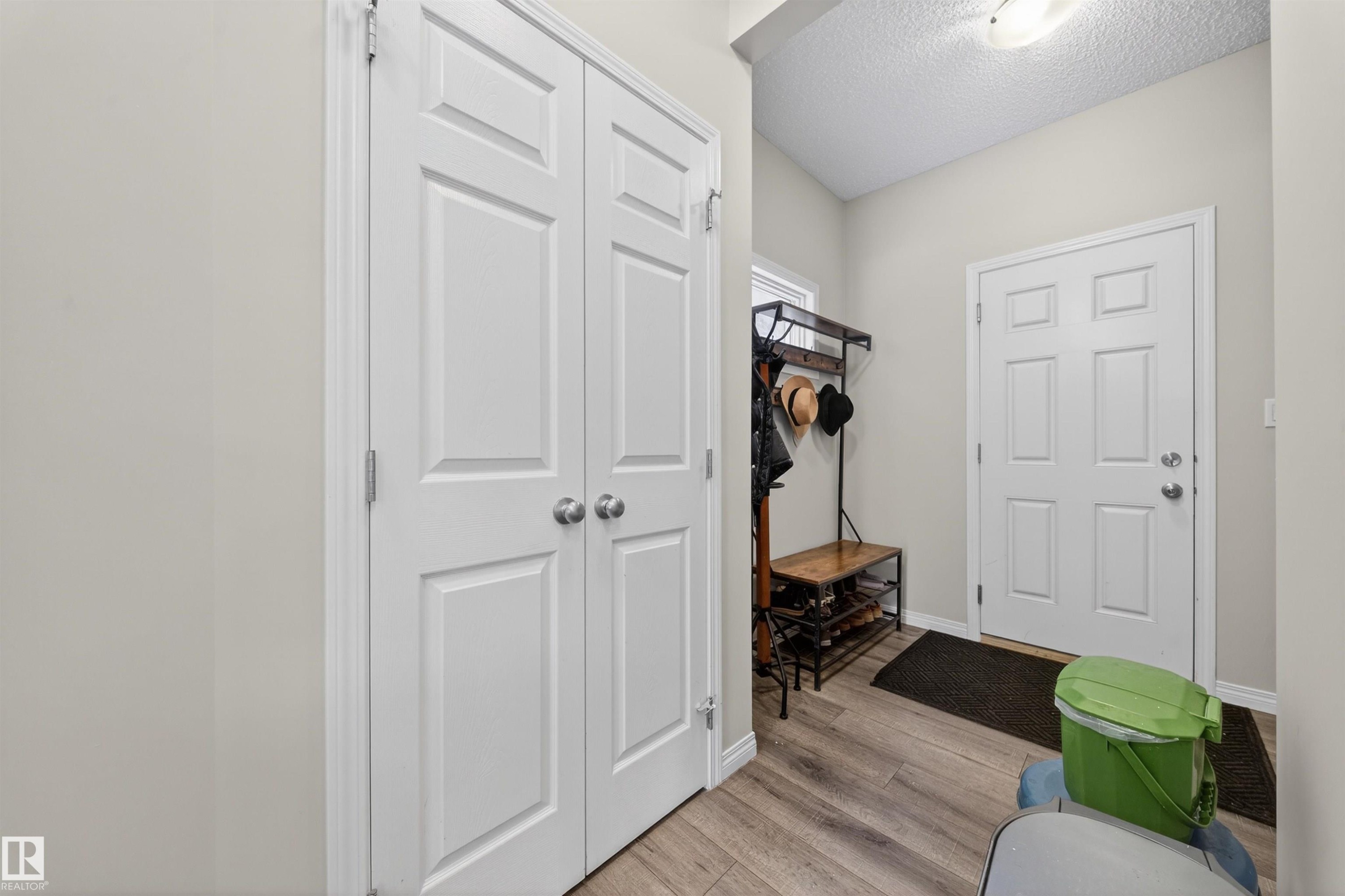 Mudroom with a textured ceiling and light wood-style flooring - 6085 King Landing, Edmonton, AB - Indoor Photo Showing Other Room