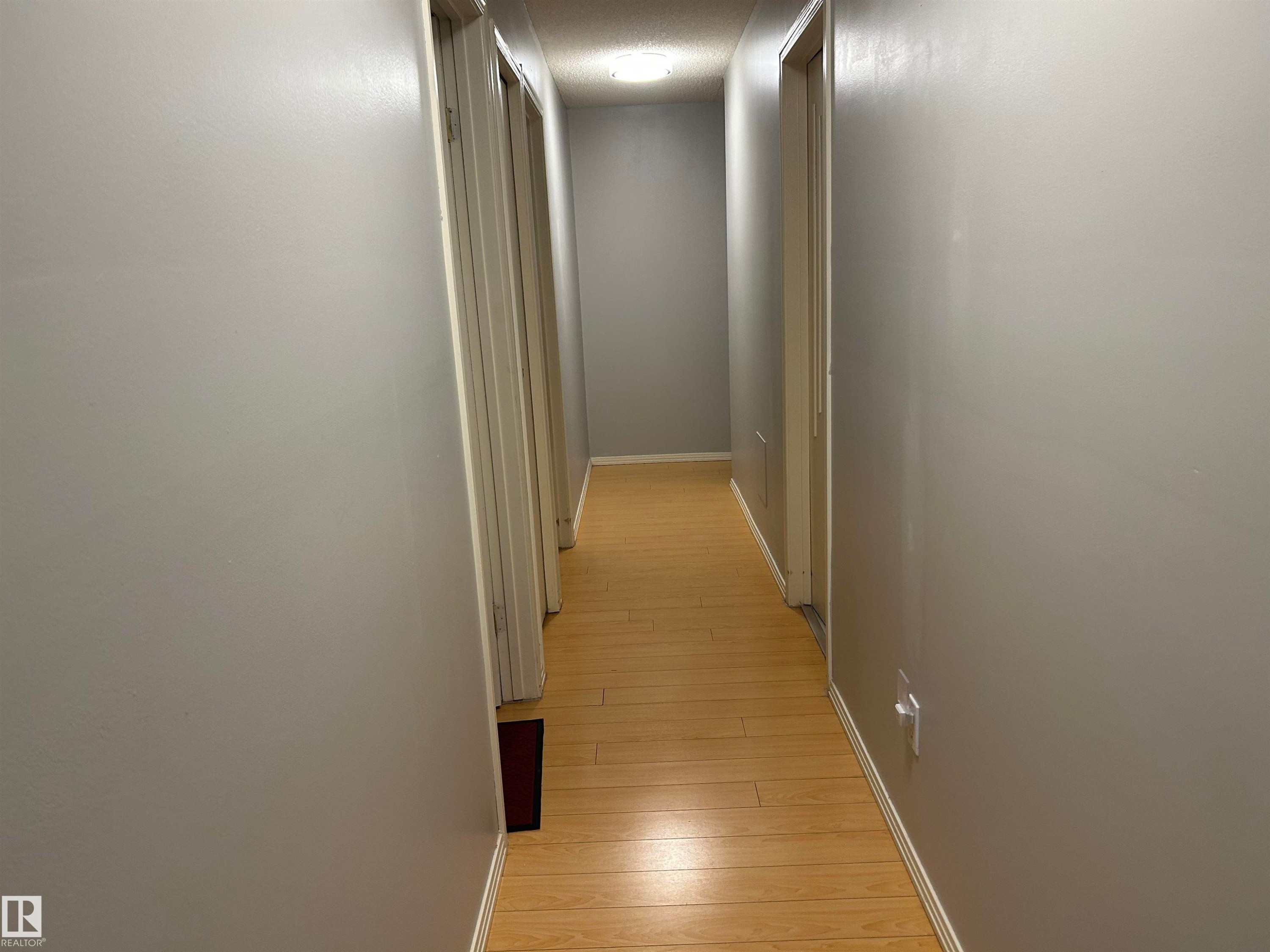 Corridor featuring baseboards and light wood-style floors - 202 18020 95 Avenue, Edmonton, AB - Indoor Photo Showing Other Room