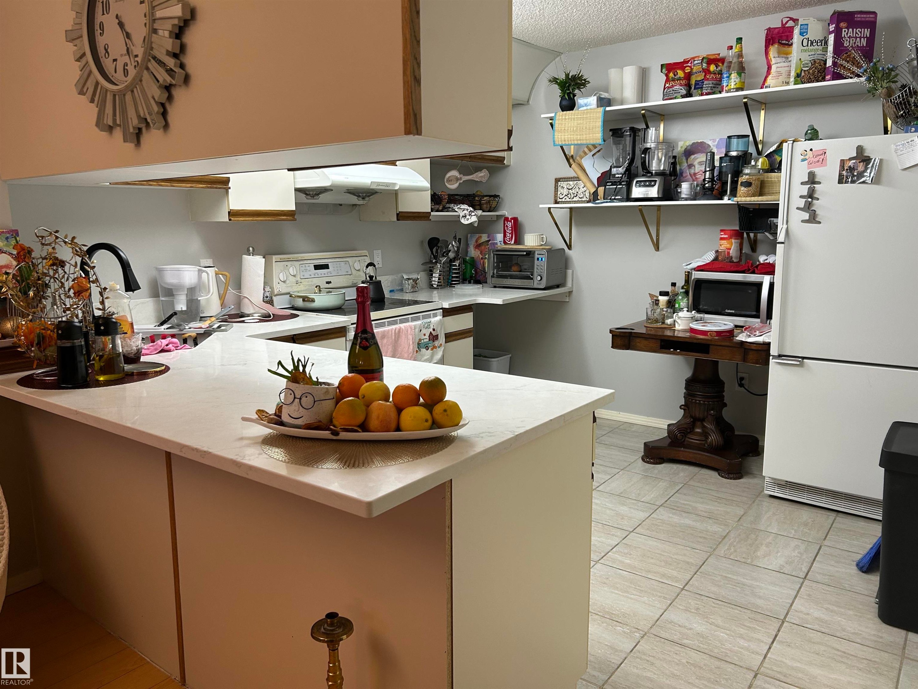 Kitchen with a peninsula, white appliances, a textured ceiling, and ventilation hood - 202 18020 95 Avenue, Edmonton, AB - Indoor Photo Showing Kitchen