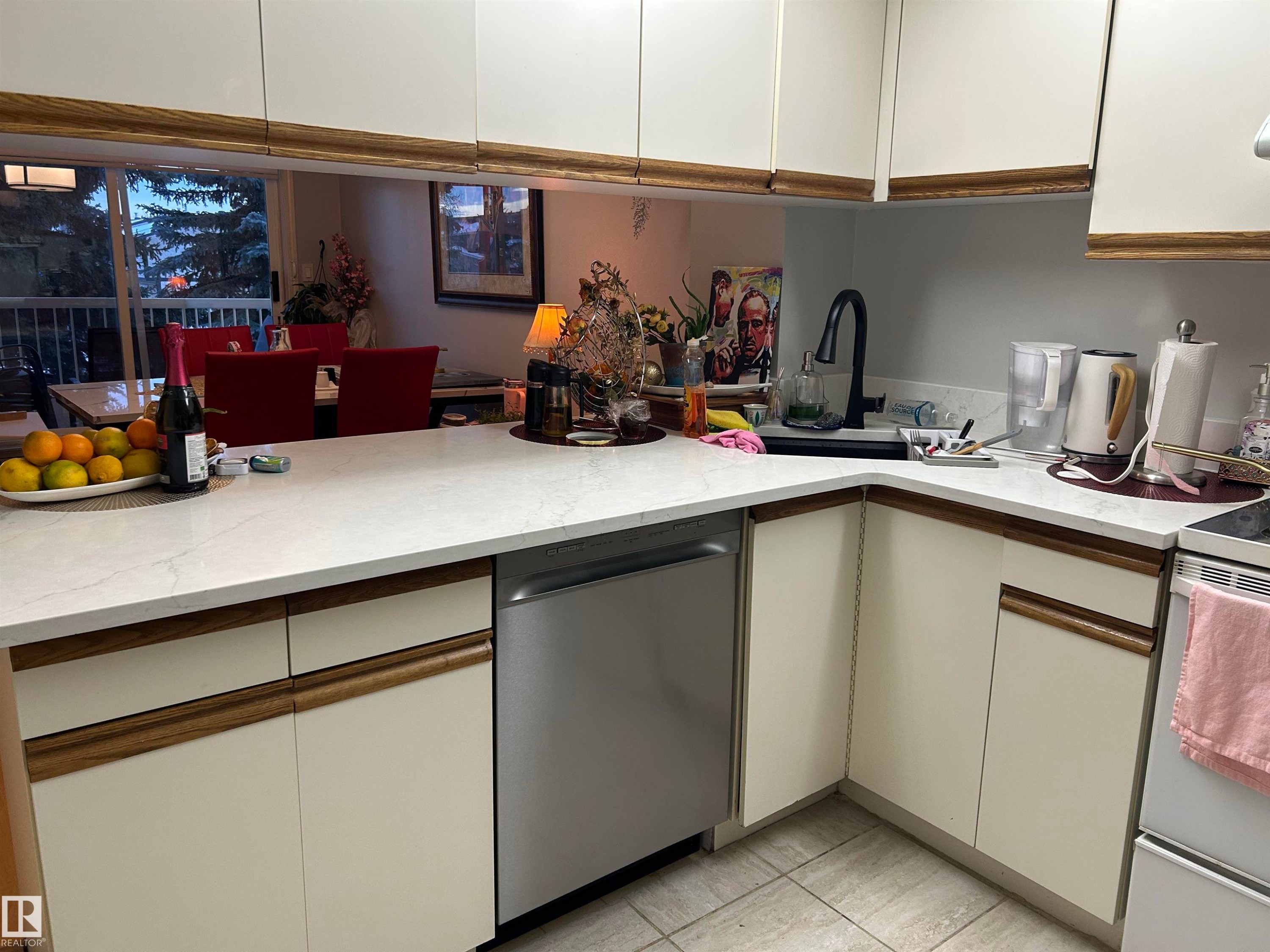 Kitchen with white cabinetry, dishwasher, white range with electric stovetop, and light stone countertops - 202 18020 95 Avenue, Edmonton, AB - Indoor Photo Showing Kitchen