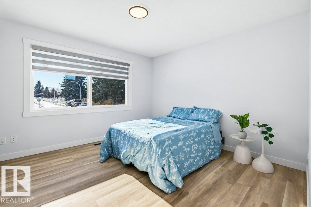 Bedroom with light wood-style floors and baseboards - 7016 92A Avenue, Edmonton, AB - Indoor Photo Showing Bedroom