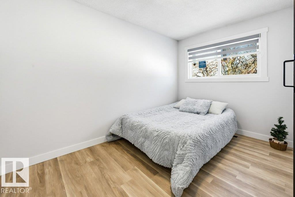 Bedroom with light wood-type flooring - 7016 92A Avenue, Edmonton, AB - Indoor Photo Showing Bedroom