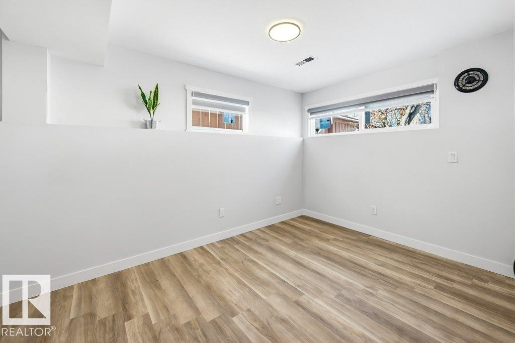 Spare room with light wood-style flooring and baseboards - 7016 92A Avenue, Edmonton, AB - Indoor Photo Showing Other Room