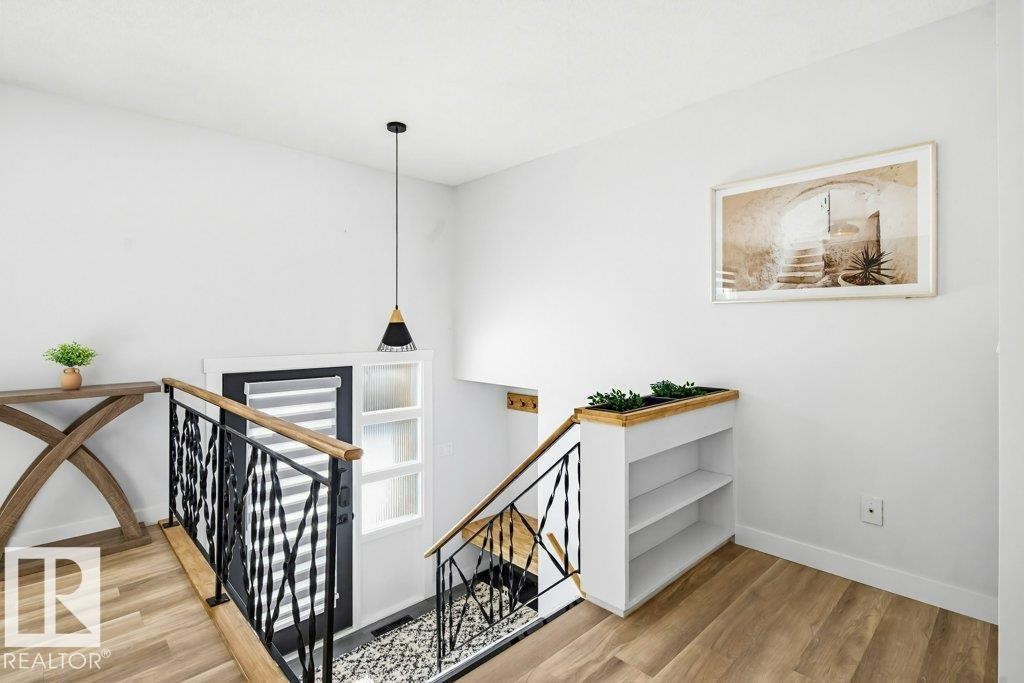 Stairs with wood finished floors and baseboards - 7016 92A Avenue, Edmonton, AB - Indoor Photo Showing Other Room