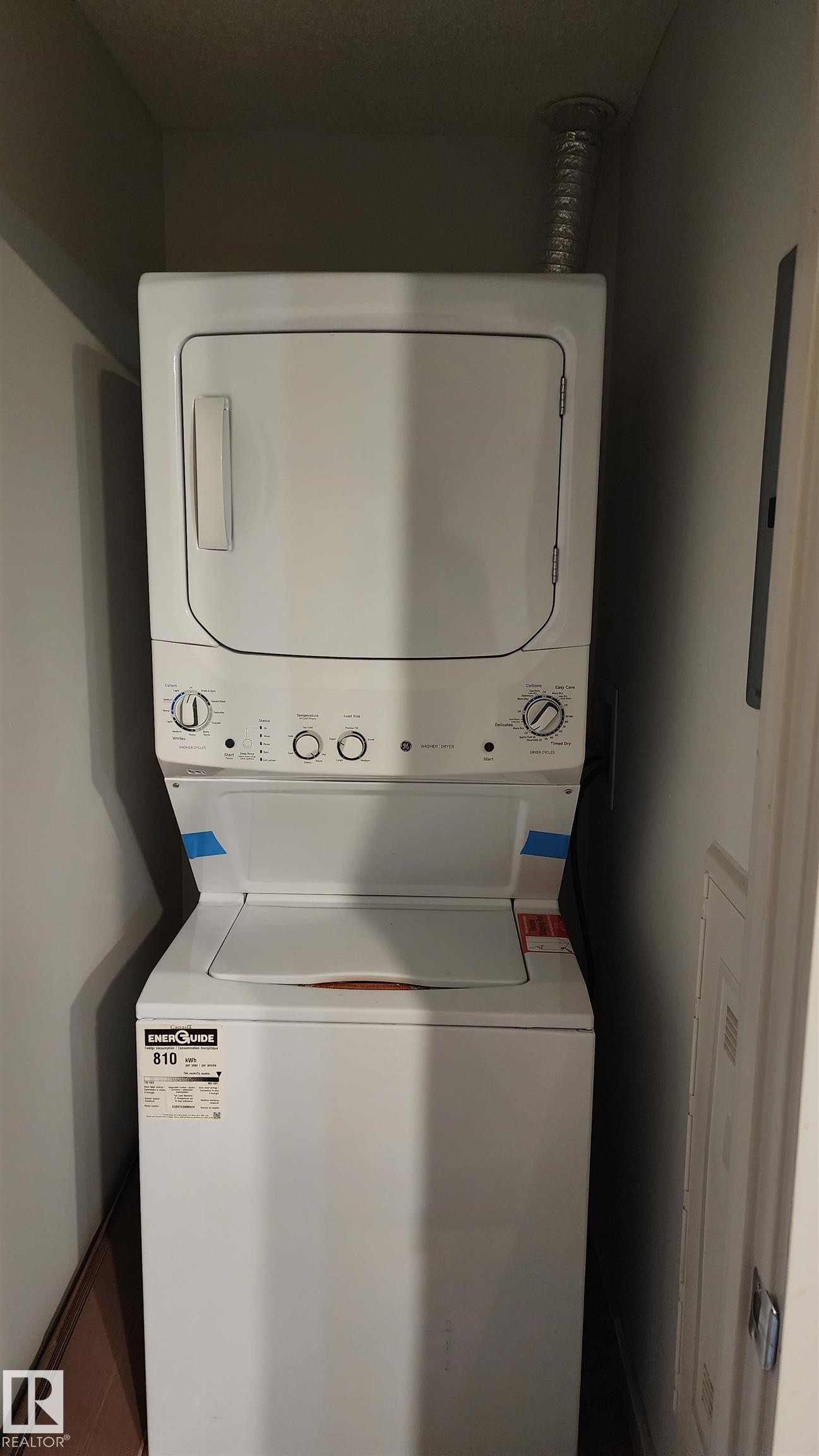 Laundry area featuring stacked washer / dryer - 413 5521 7 Avenue, Edmonton, AB - Indoor Photo Showing Laundry Room