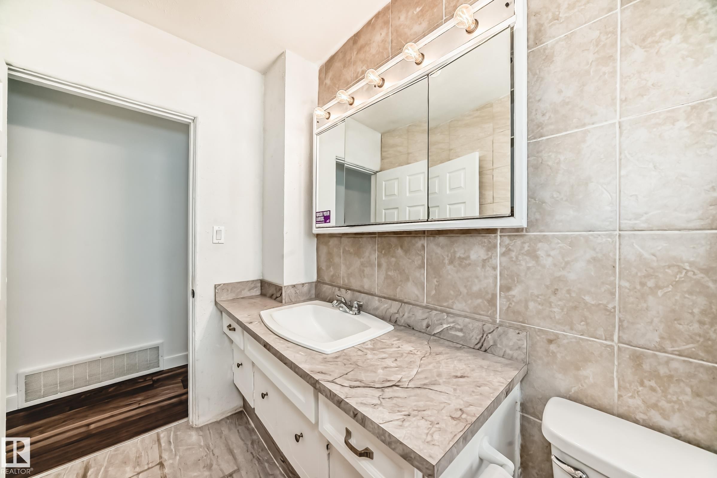 Bathroom with vanity and tile walls - 13904 135 Avenue, Edmonton, AB - Indoor Photo Showing Bathroom