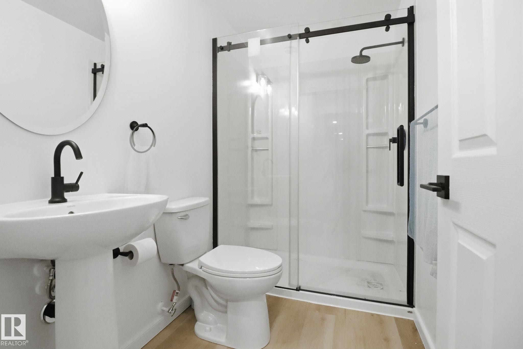 Bathroom featuring a stall shower and light wood finished floors - 3234 Chernowski Way, Edmonton, AB - Indoor Photo Showing Bathroom