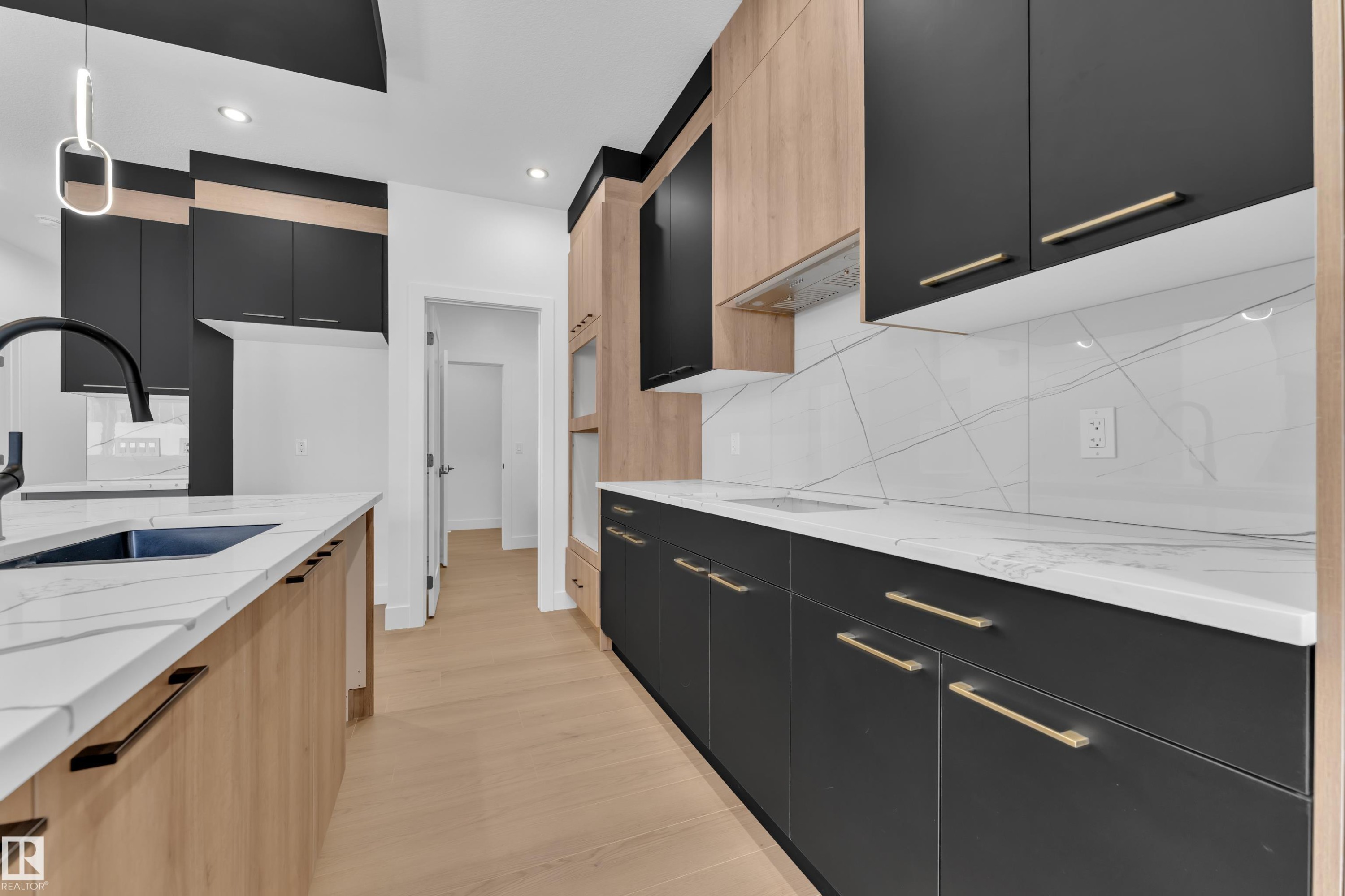 Two tone kitchen featuring dual tone cabinetry, light stone counters, modern cabinets, pendant lighting, and backsplash - 741 Astoria Way, Devon, AB - Indoor Photo Showing Kitchen