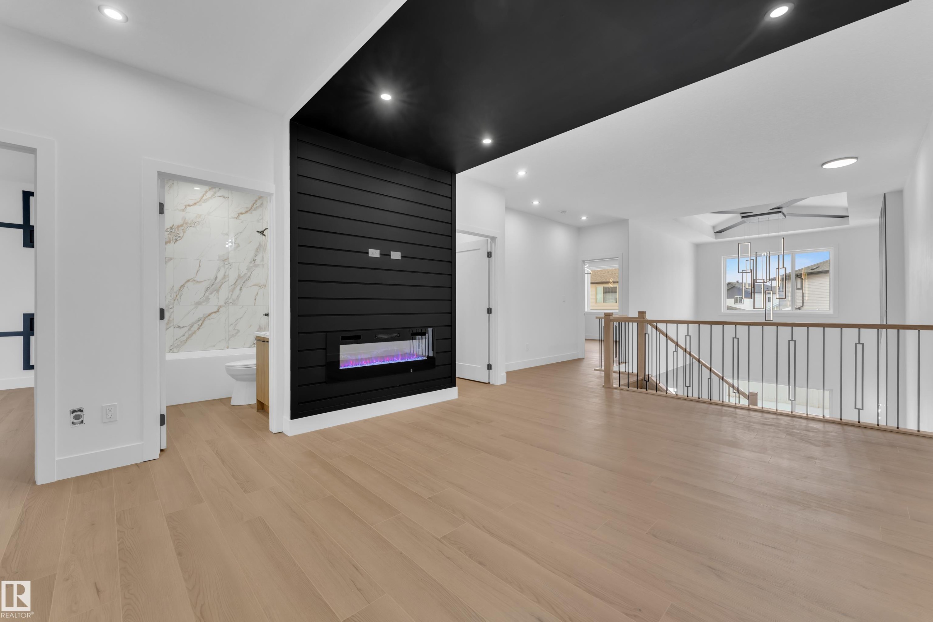 Unfurnished living room with a fireplace, recessed lighting, and light wood-style floors - 741 Astoria Way, Devon, AB - Indoor Photo Showing Other Room