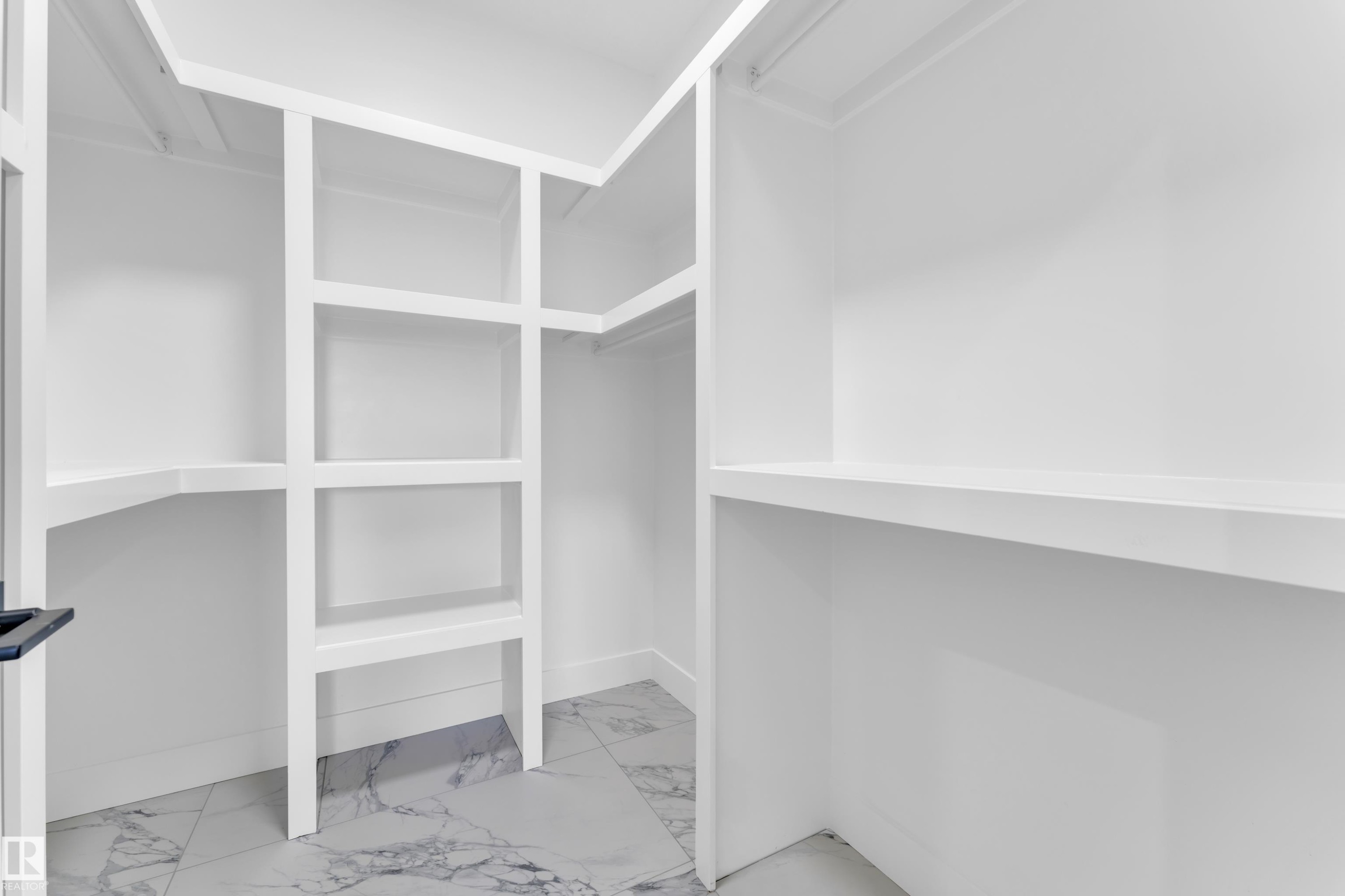 Walk in closet featuring light marble finish floors - 741 Astoria Way, Devon, AB - Indoor With Storage