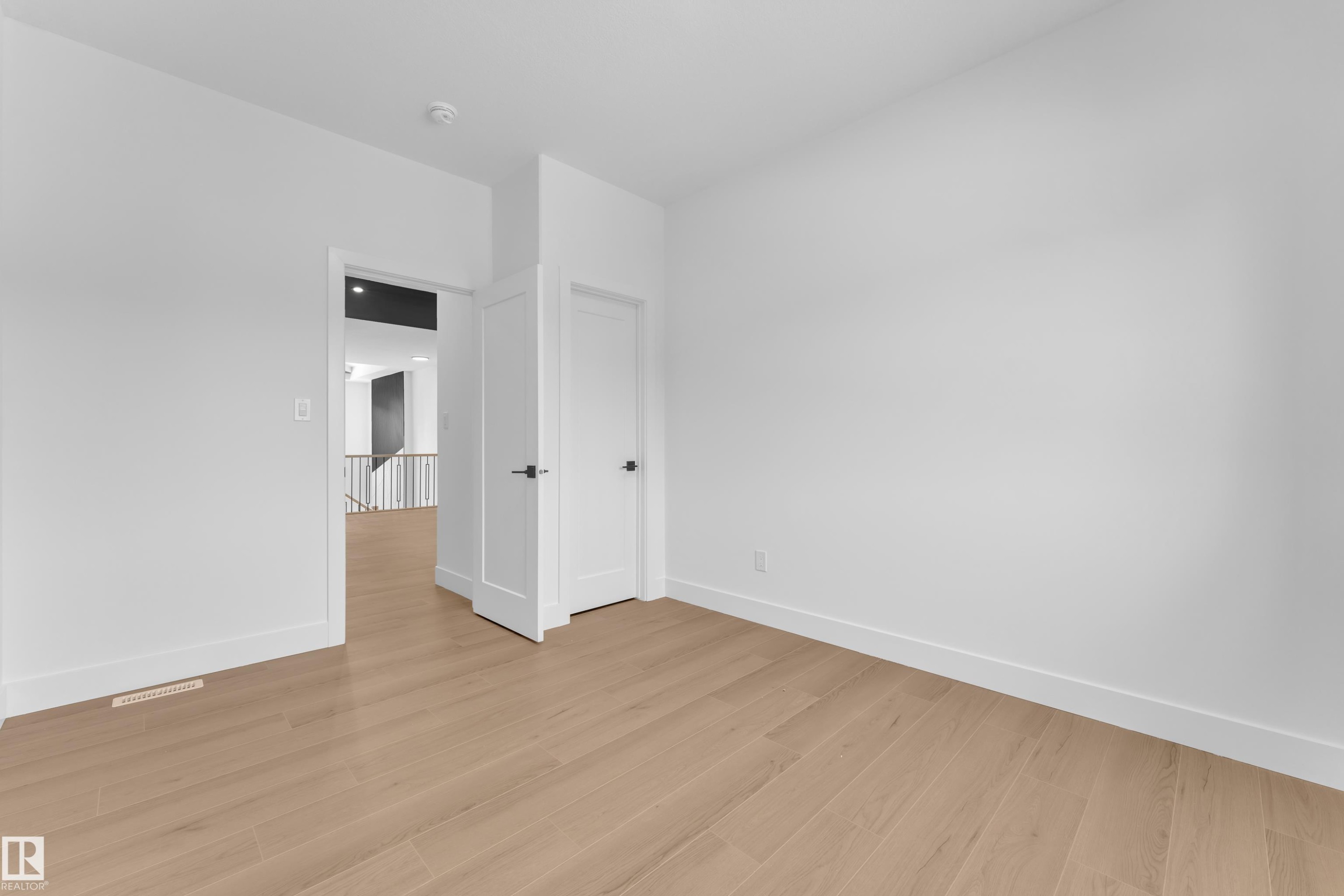 Spare room featuring baseboards and light wood-style flooring - 741 Astoria Way, Devon, AB - Indoor Photo Showing Other Room