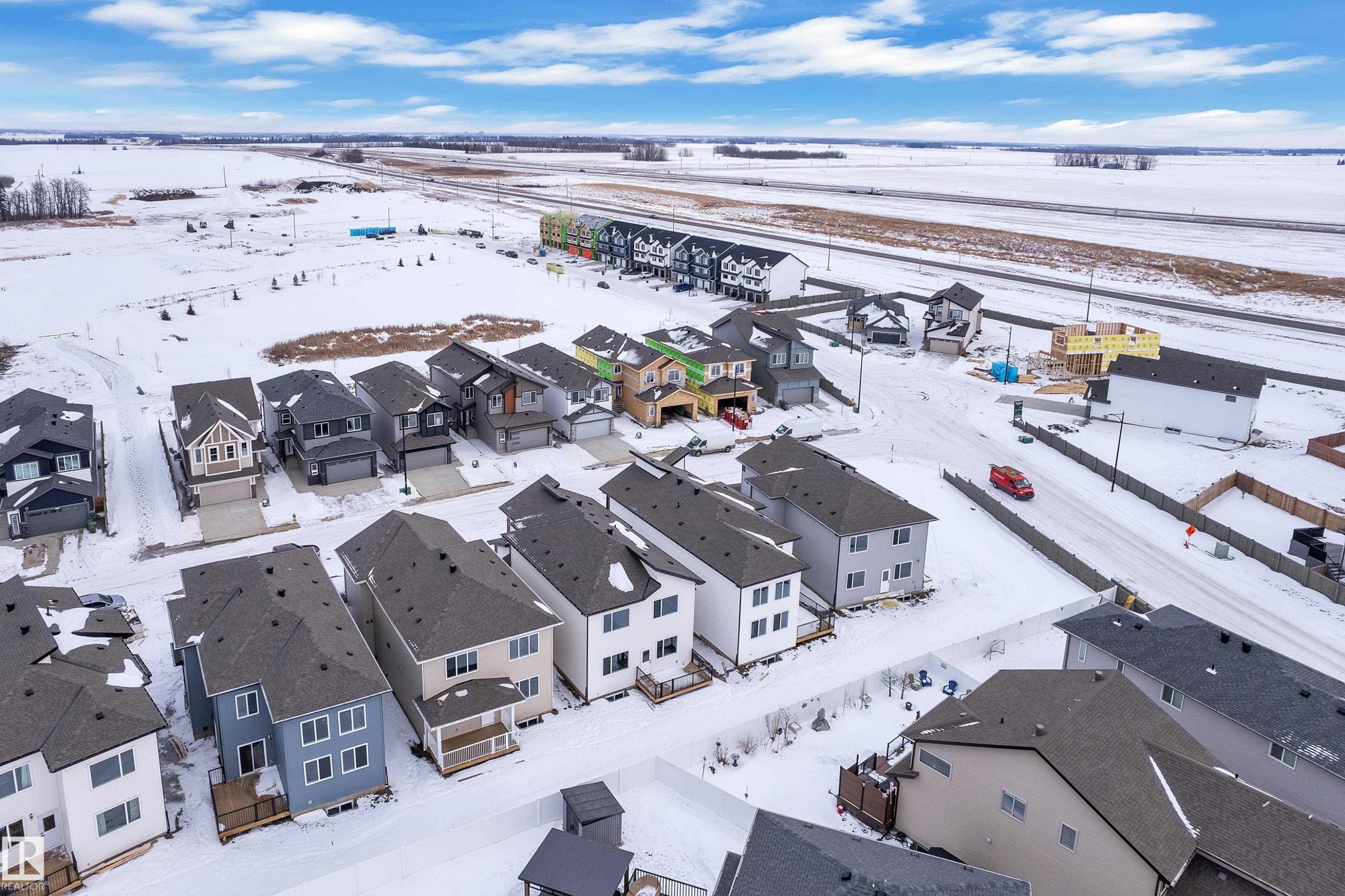 Snowy aerial view featuring a residential view - 741 Astoria Way, Devon, AB - Outdoor With Body Of Water With View
