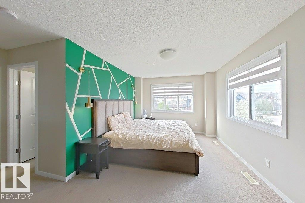 Bedroom featuring light colored carpet and a textured ceiling - 4303 Prowse Link, Edmonton, AB - Indoor Photo Showing Bedroom