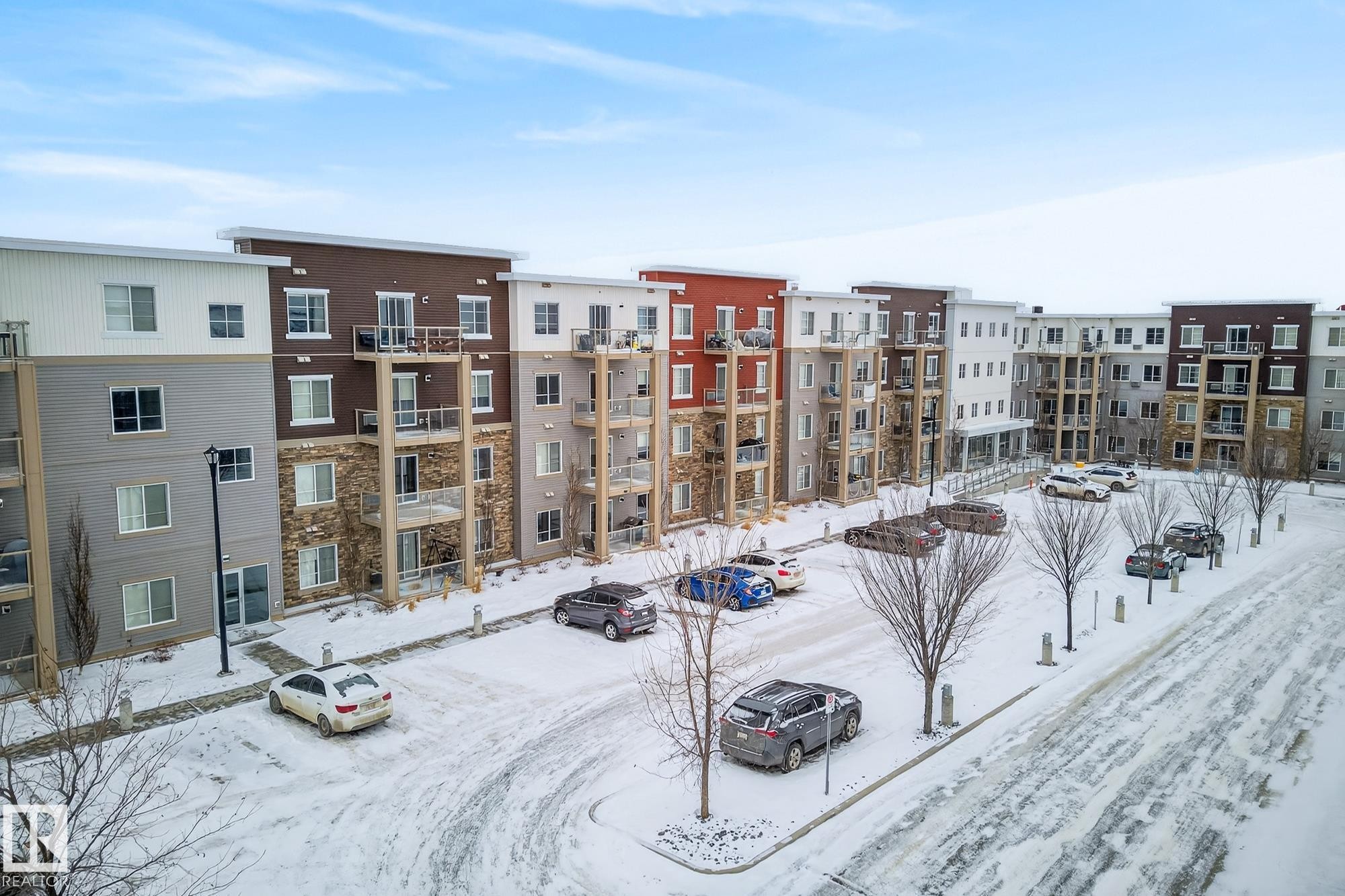 Snow covered property with uncovered parking and a view of apartment building / complex - 206 812 Welsh Drive, Edmonton, AB - Outdoor With Balcony