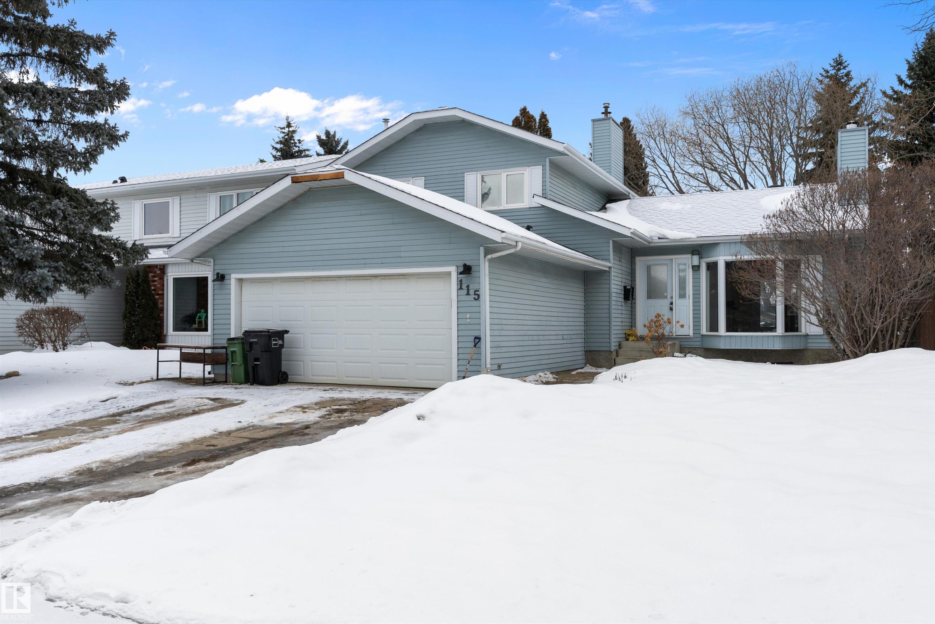 Traditional home featuring a chimney and a garage - 115 Walker Road, Edmonton, AB - Outdoor With Facade