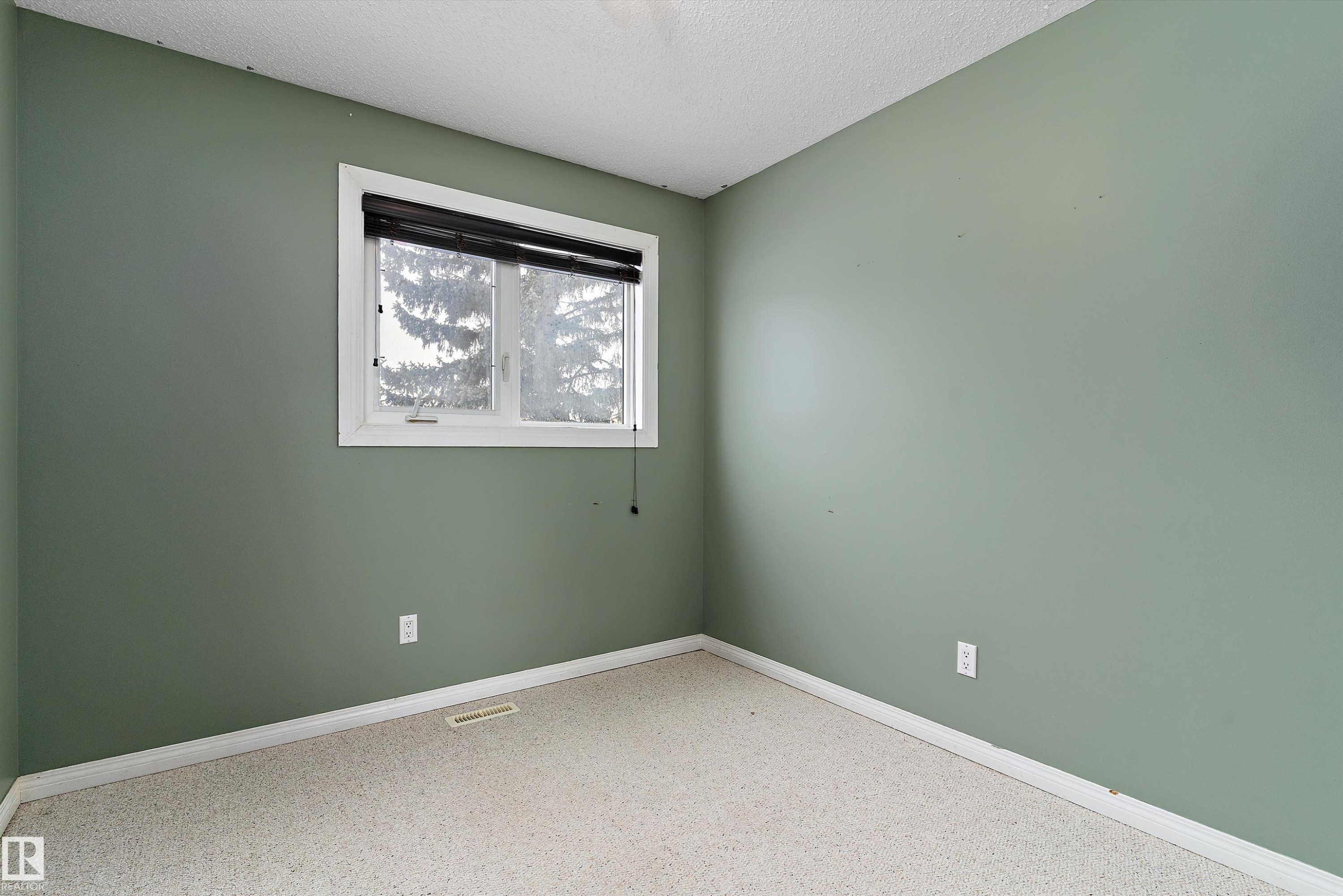 Empty room with a textured ceiling and baseboards - 115 Walker Road, Edmonton, AB - Indoor Photo Showing Other Room