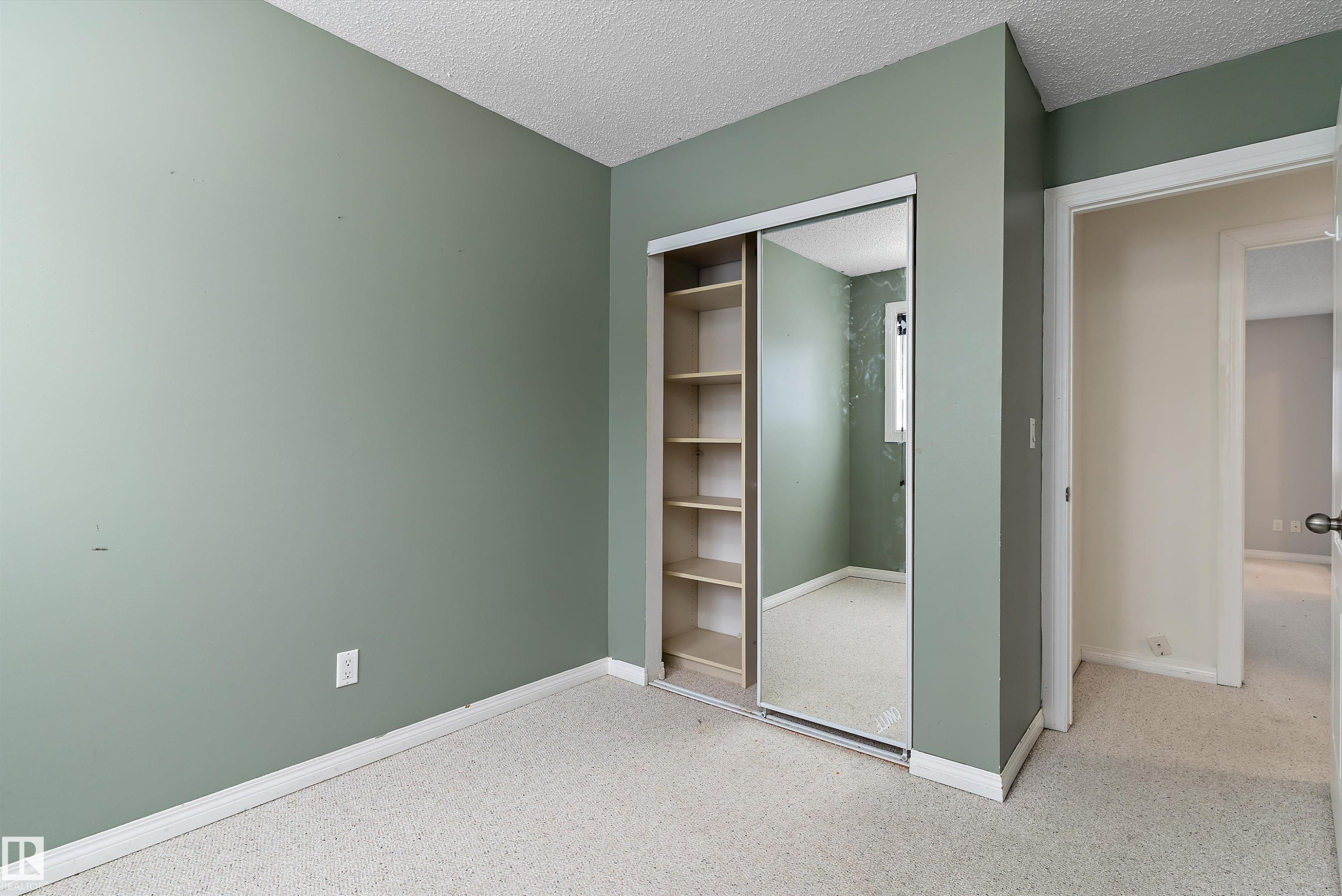 Unfurnished bedroom featuring a textured ceiling and a closet - 115 Walker Road, Edmonton, AB - Indoor Photo Showing Other Room