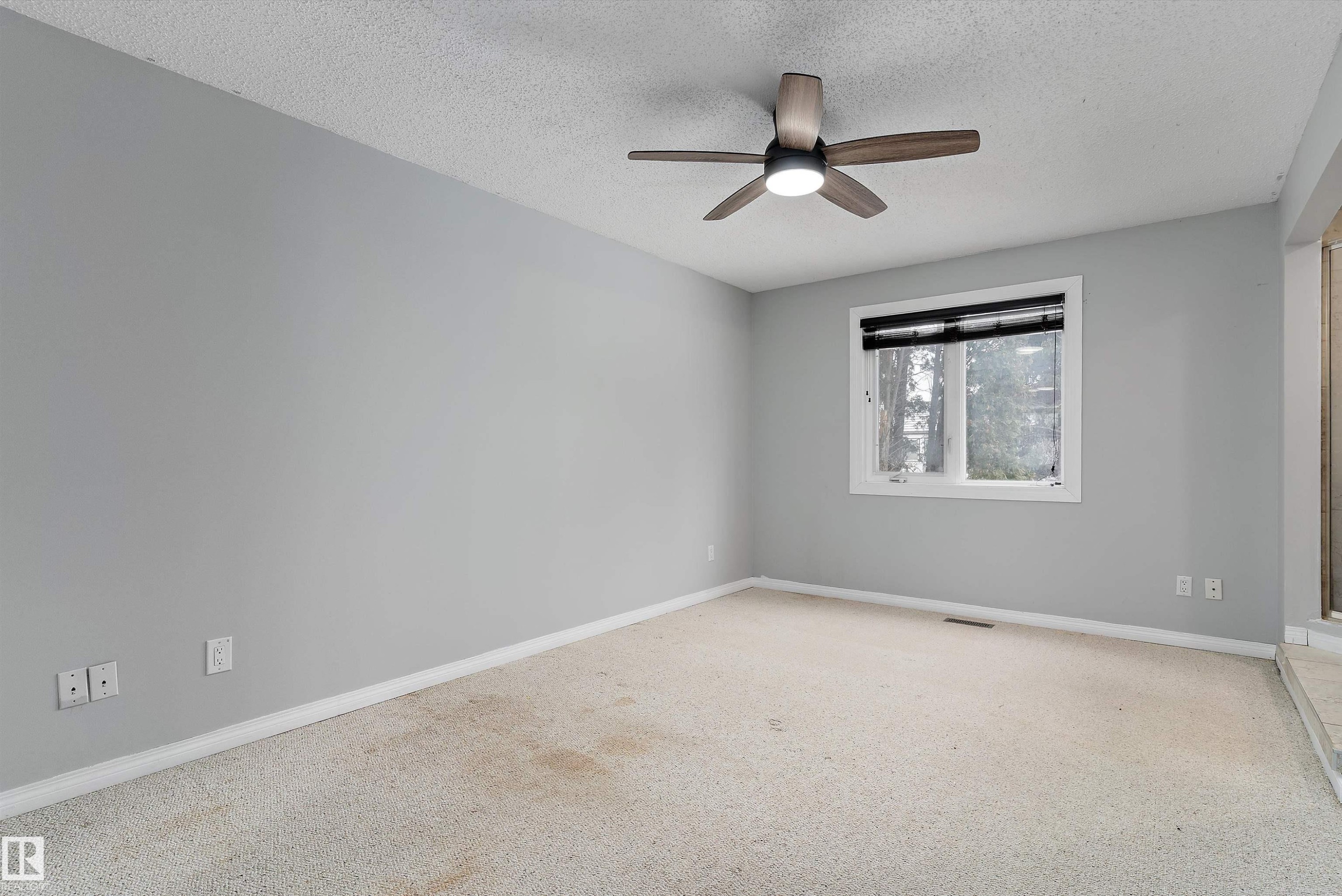 Empty room featuring a textured ceiling, ceiling fan, and carpet - 115 Walker Road, Edmonton, AB - Indoor Photo Showing Other Room