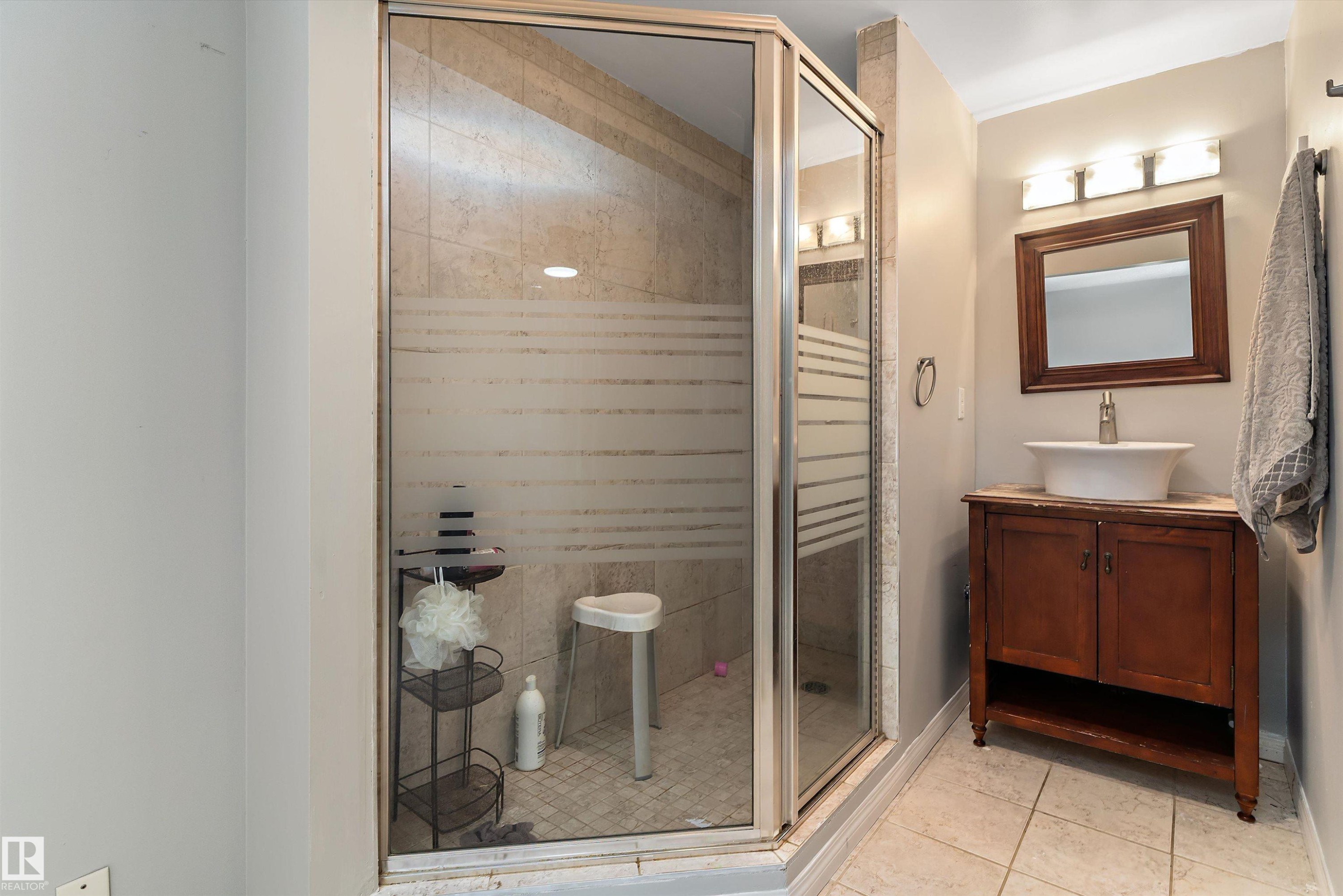 Full bathroom with vanity, a shower stall, and light tile patterned floors - 115 Walker Road, Edmonton, AB - Indoor Photo Showing Other Room