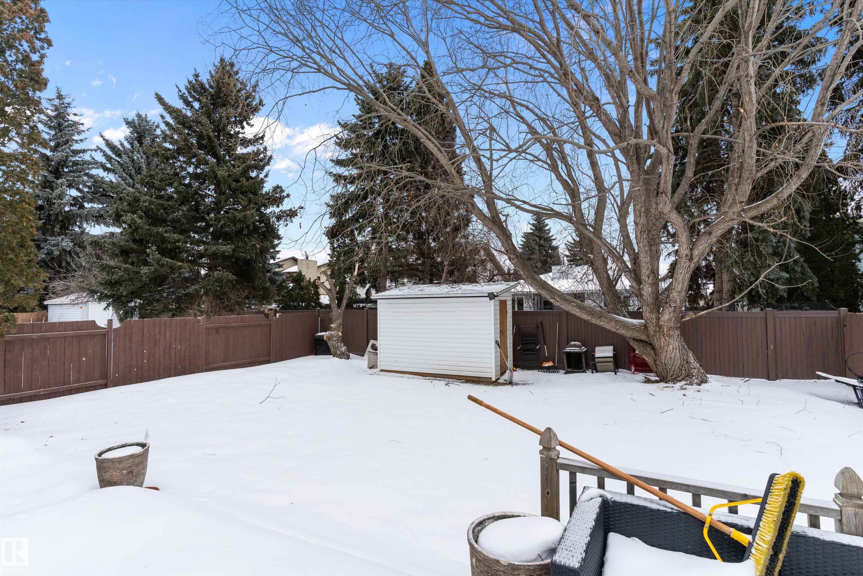 Snowy yard featuring a fenced backyard and a storage shed - 115 Walker Road, Edmonton, AB - Outdoor
