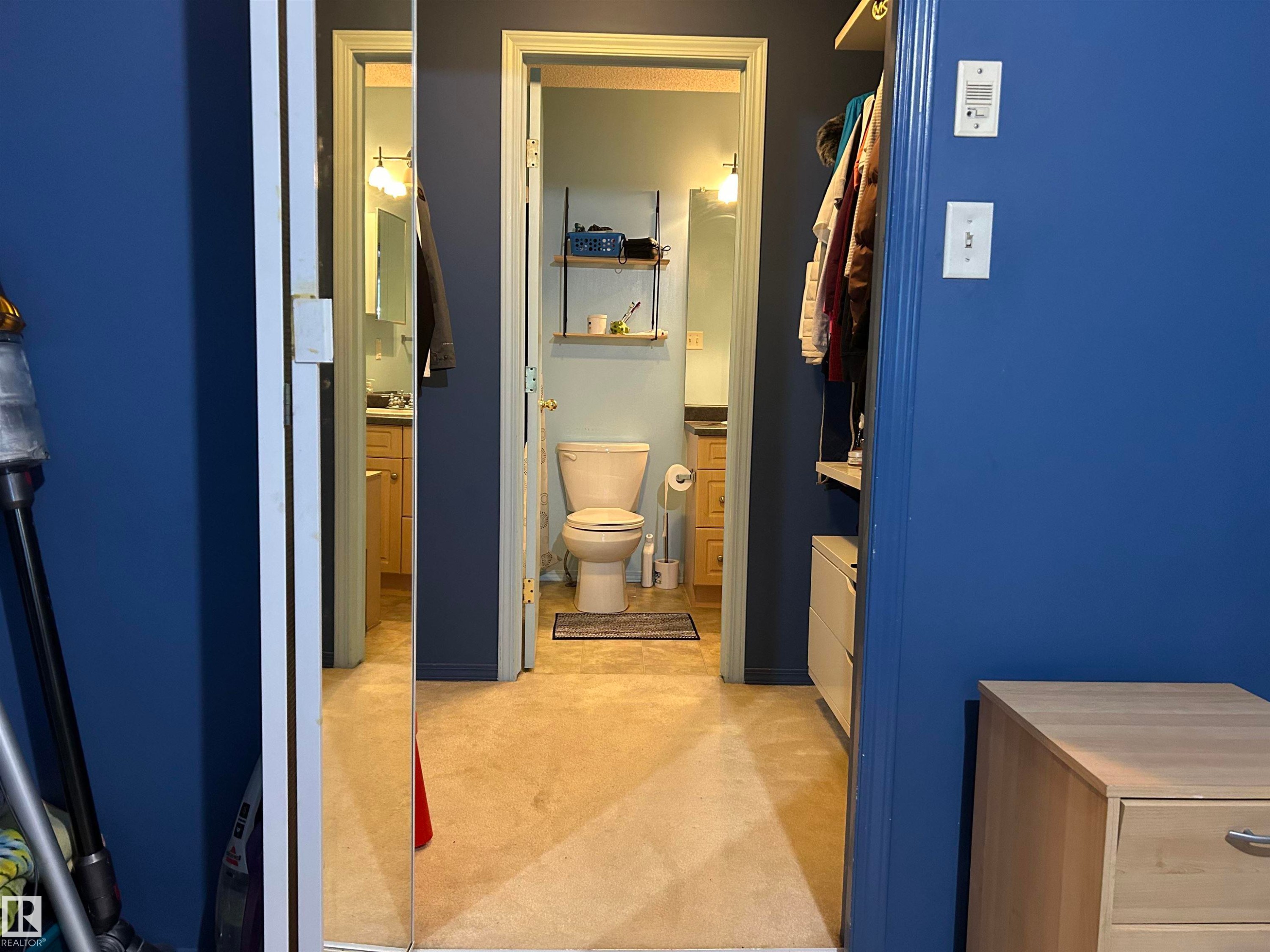 Bathroom with light carpet and vanity - 310 2430 Guardian Road, Edmonton, AB - Indoor