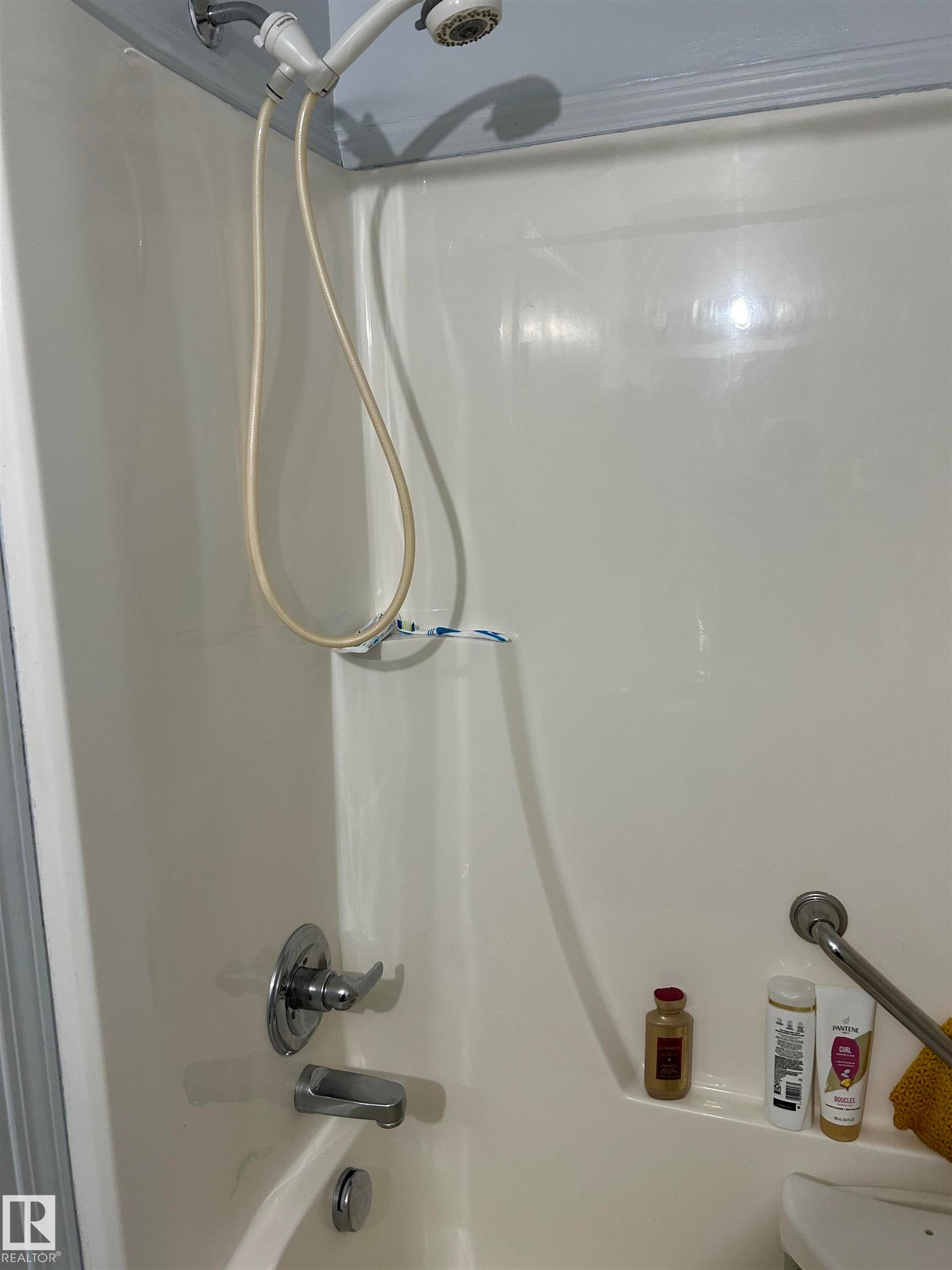 Bathroom view of washtub / shower combination - 310 2430 Guardian Road, Edmonton, AB - Indoor Photo Showing Bathroom