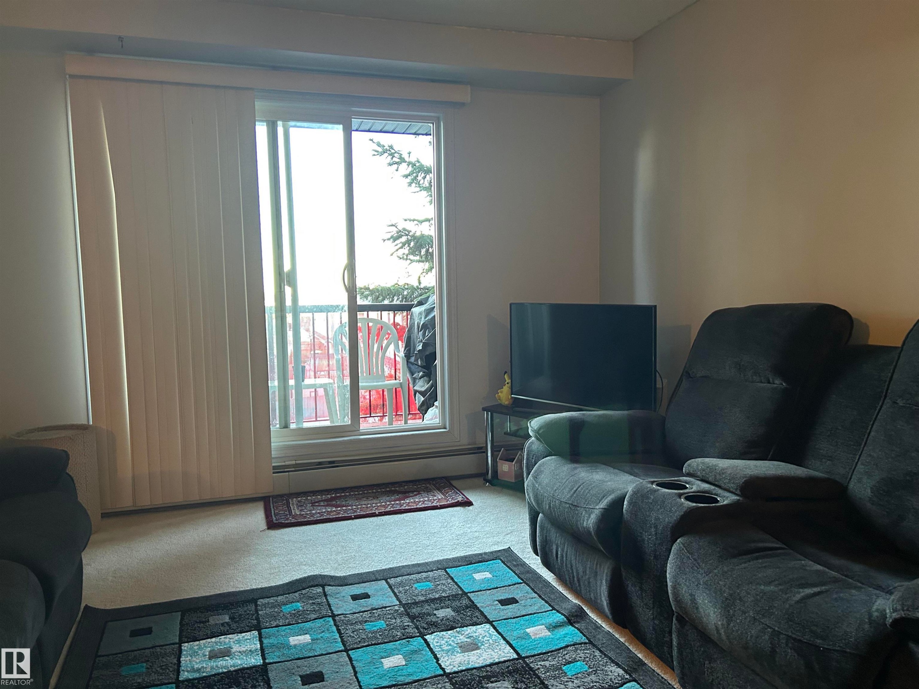 Sitting room featuring carpet floors - 310 2430 Guardian Road, Edmonton, AB - Indoor Photo Showing Living Room