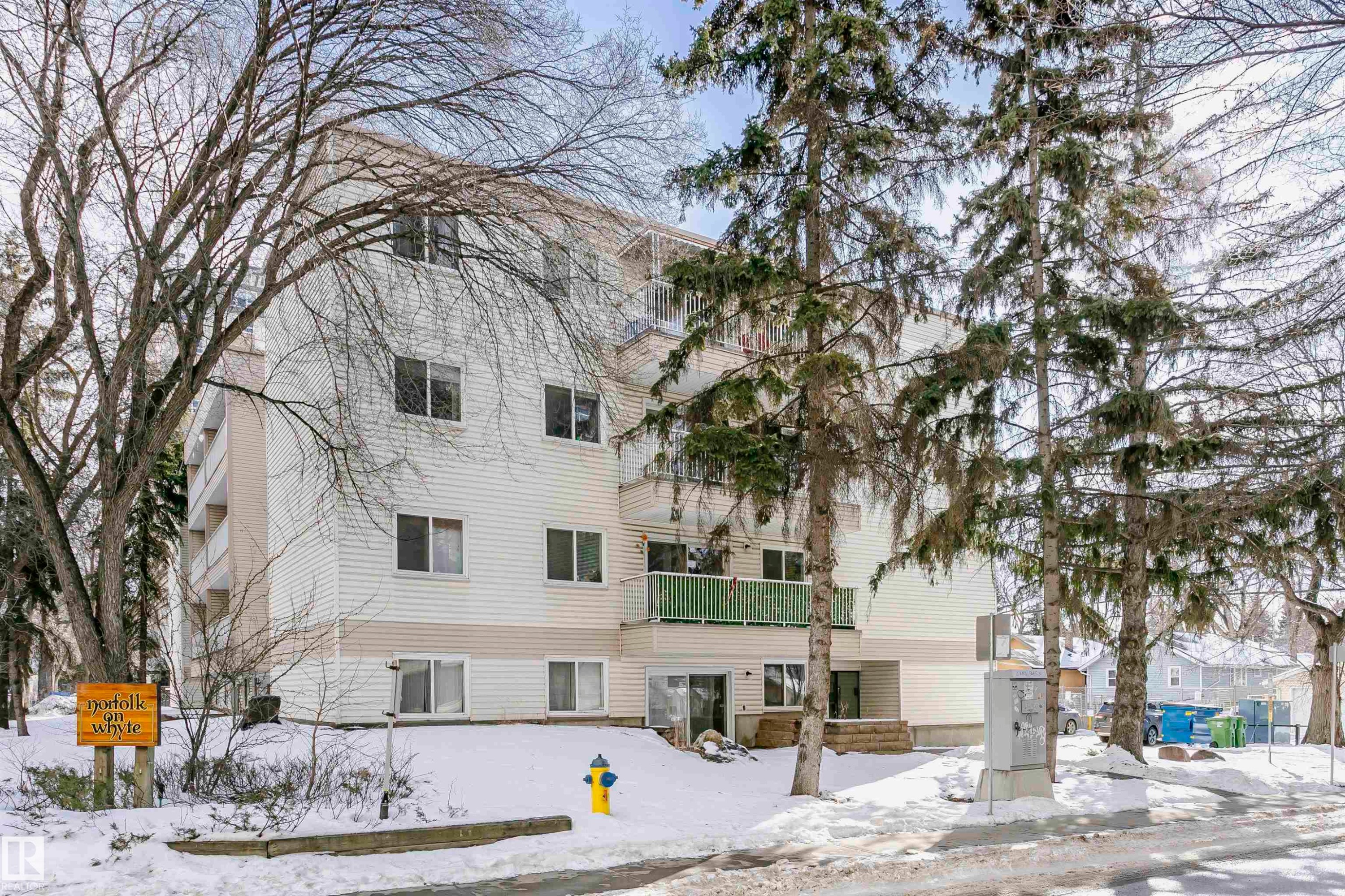 Snow covered building featuring a view of apartment building / complex - 407 8149 111 St S, Edmonton, AB - Outdoor