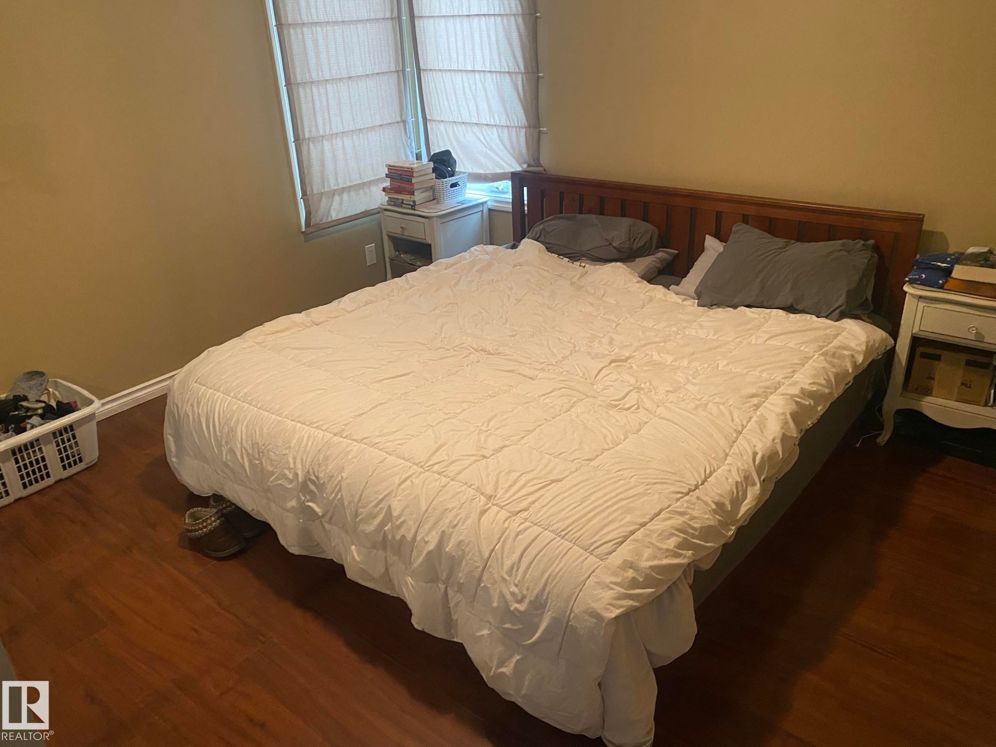 Bedroom featuring dark wood finished floors - 10945 54 Avenue, Edmonton, AB - Indoor Photo Showing Bedroom