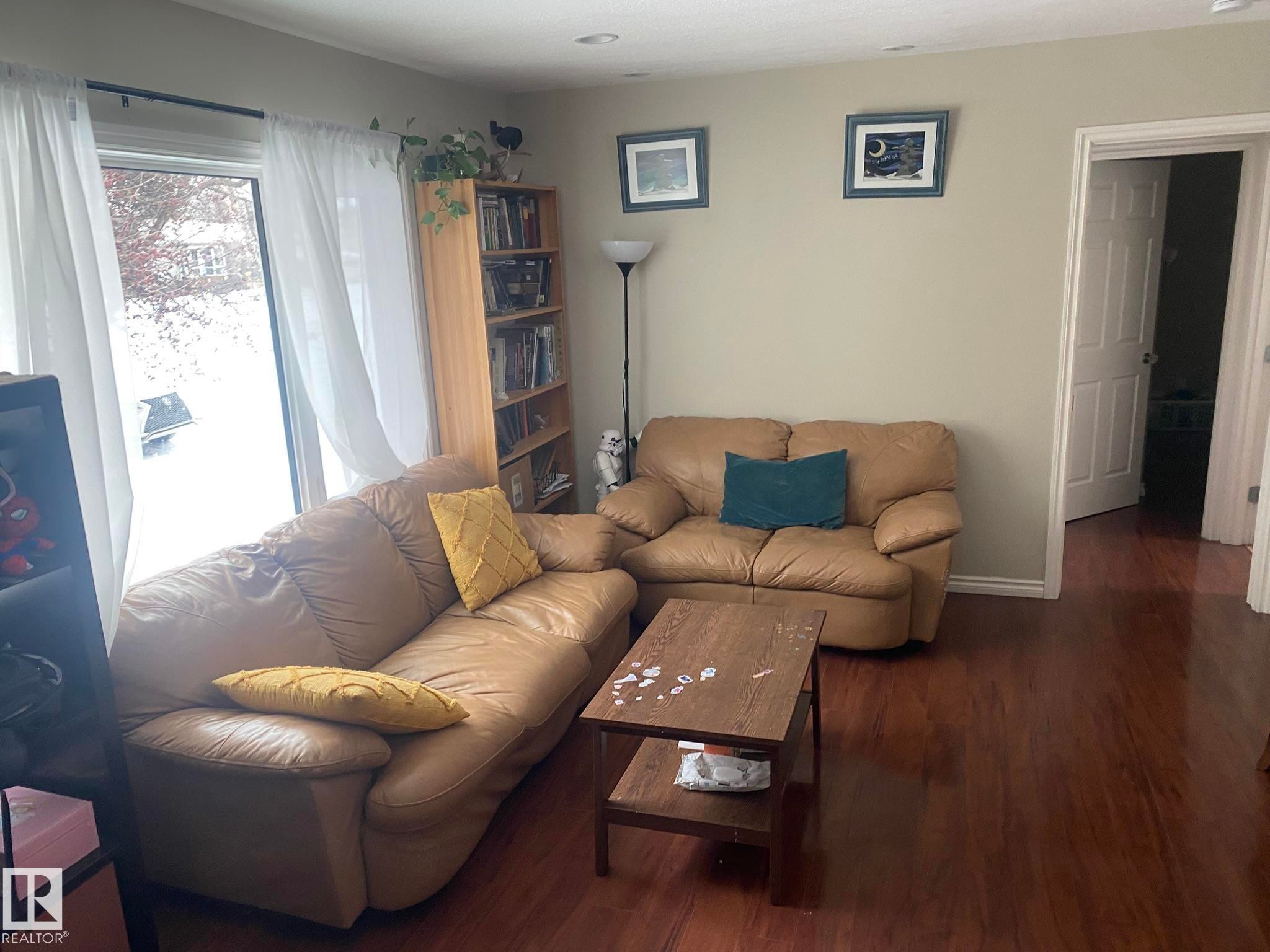 Living room with wood finished floors and baseboards - 10945 54 Avenue, Edmonton, AB - Indoor Photo Showing Living Room