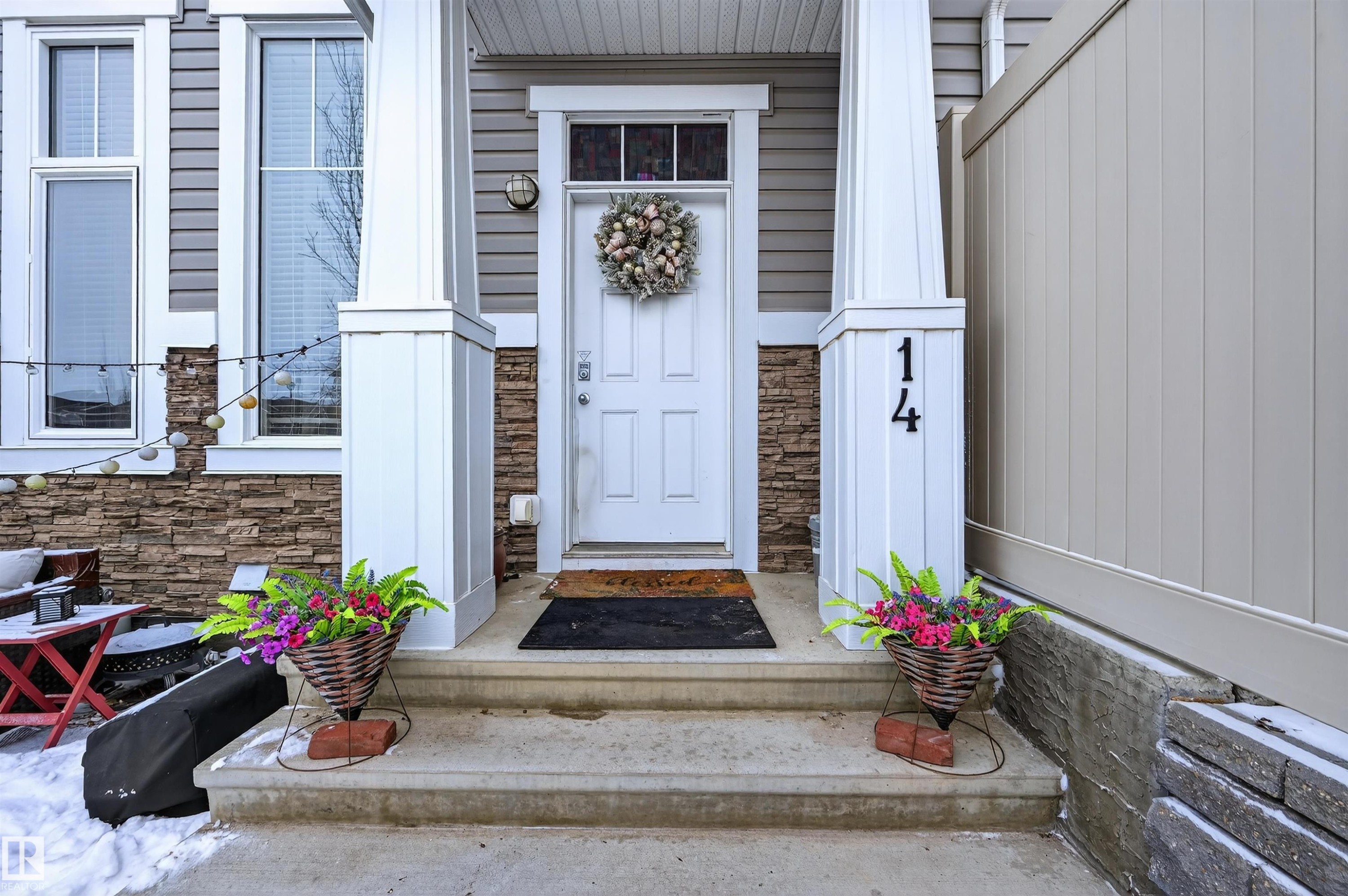 Entrance to property featuring stone siding - 14 1140 Chappelle Boulevard, Edmonton, AB - Outdoor