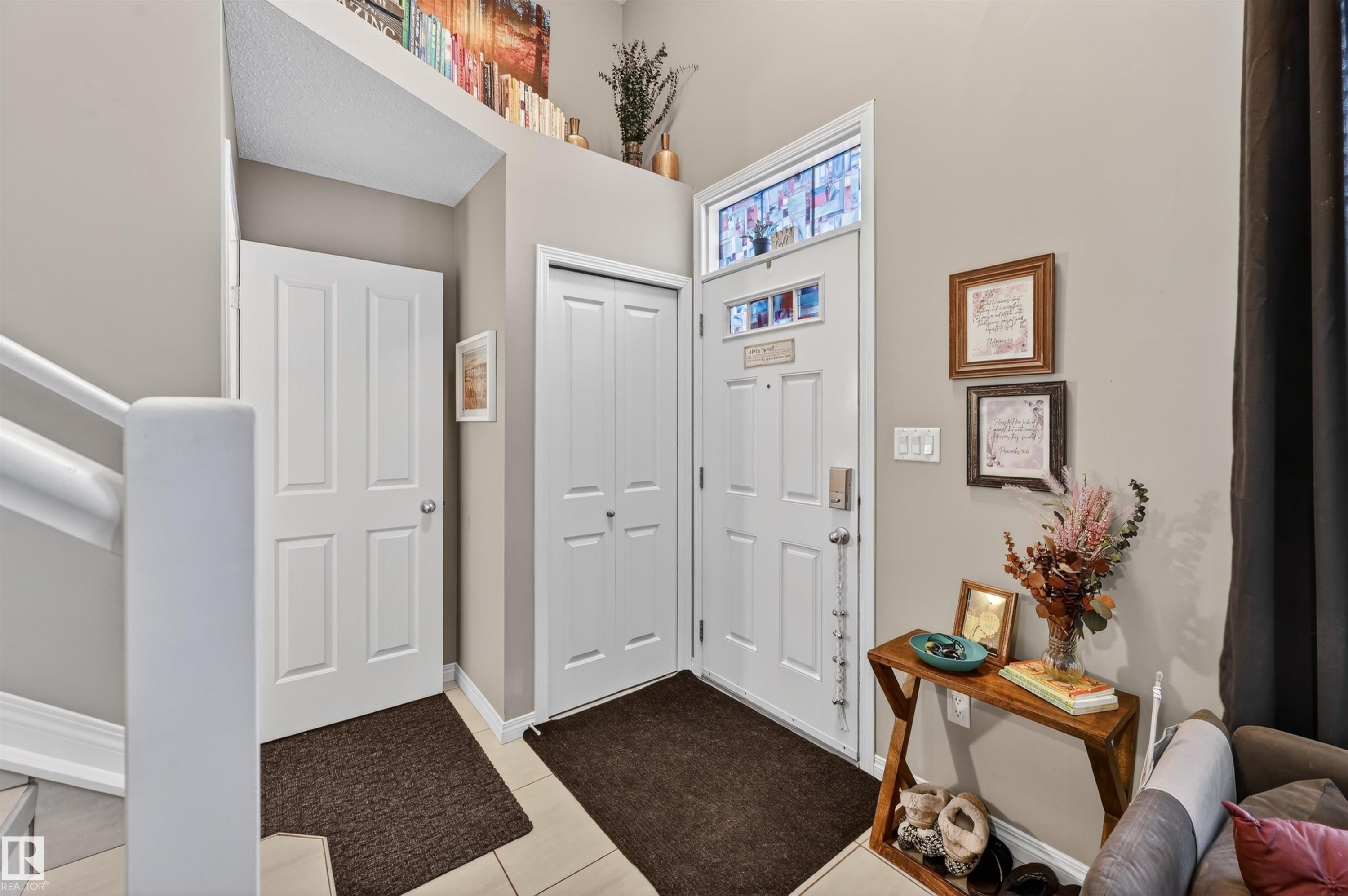 Entryway featuring baseboards and light tile patterned floors - 14 1140 Chappelle Boulevard, Edmonton, AB - Indoor Photo Showing Other Room