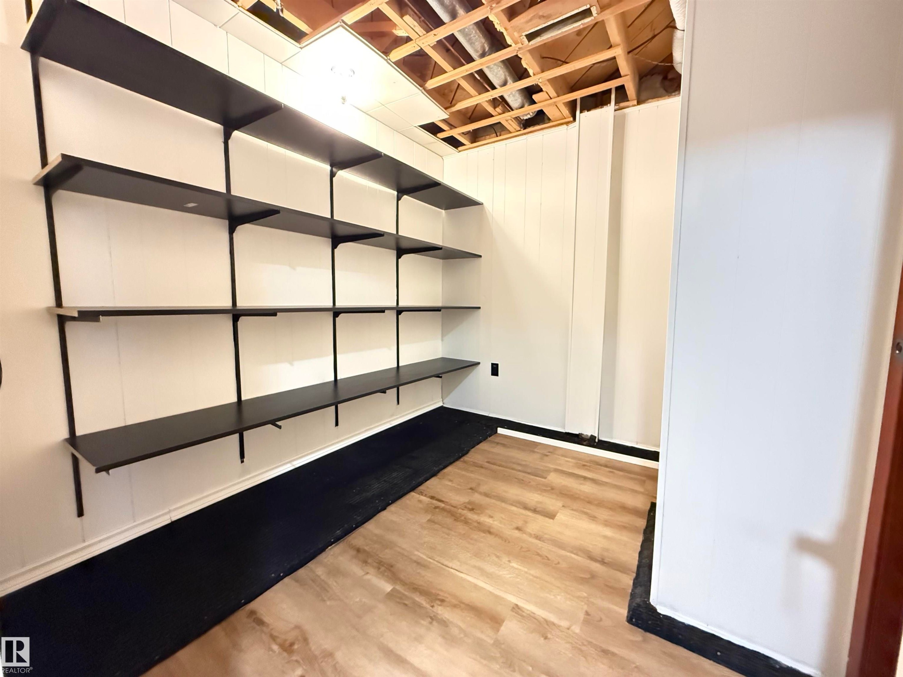 Basement featuring light wood-style flooring - 9034 60 Street, Edmonton, AB - Indoor