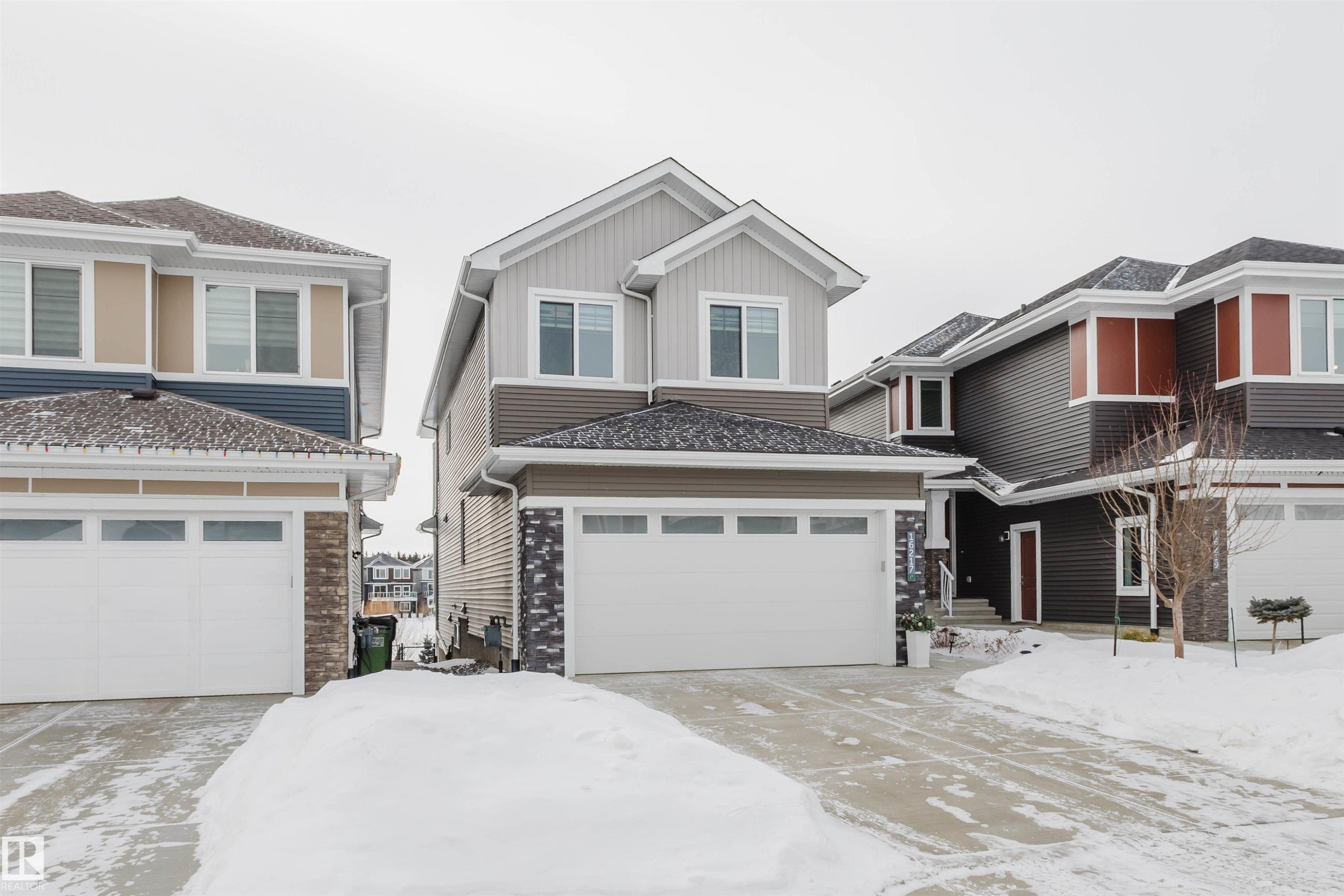 View of front facade featuring board and batten siding and driveway - 16217 32 Avenue, Edmonton, AB - Outdoor With Facade