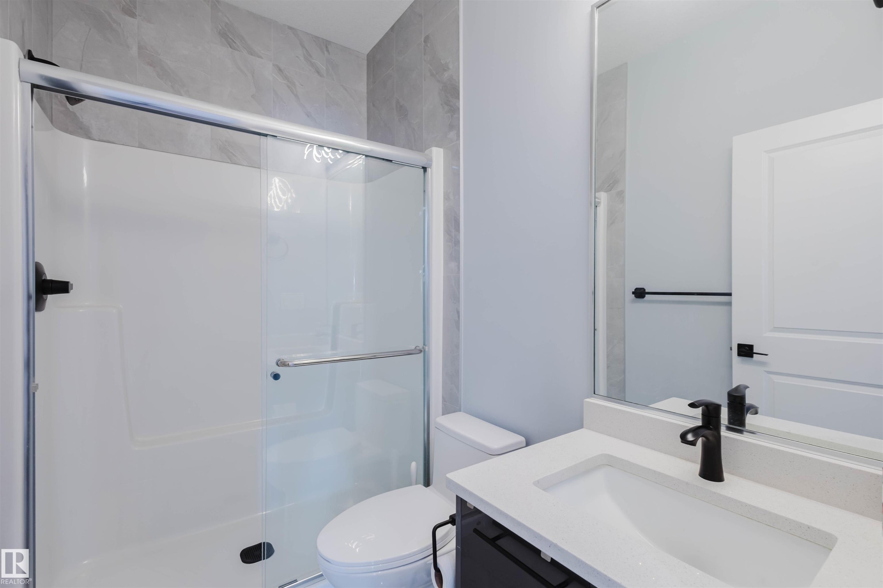 Main floor Full bath featuring vanity and a shower stall - 16217 32 Avenue, Edmonton, AB - Indoor Photo Showing Bathroom