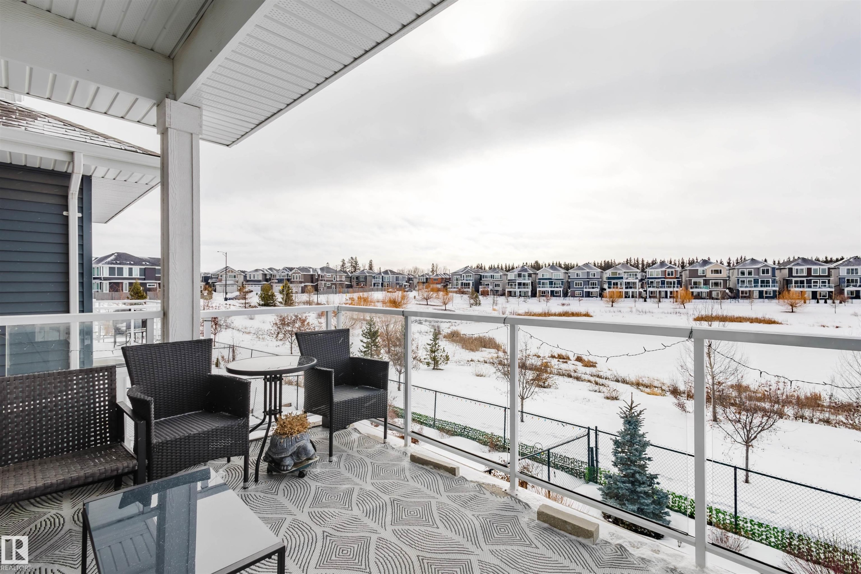 Snow covered back of property featuring a residential view and an outdoor hangout area - 16217 32 Avenue, Edmonton, AB - Outdoor With Balcony