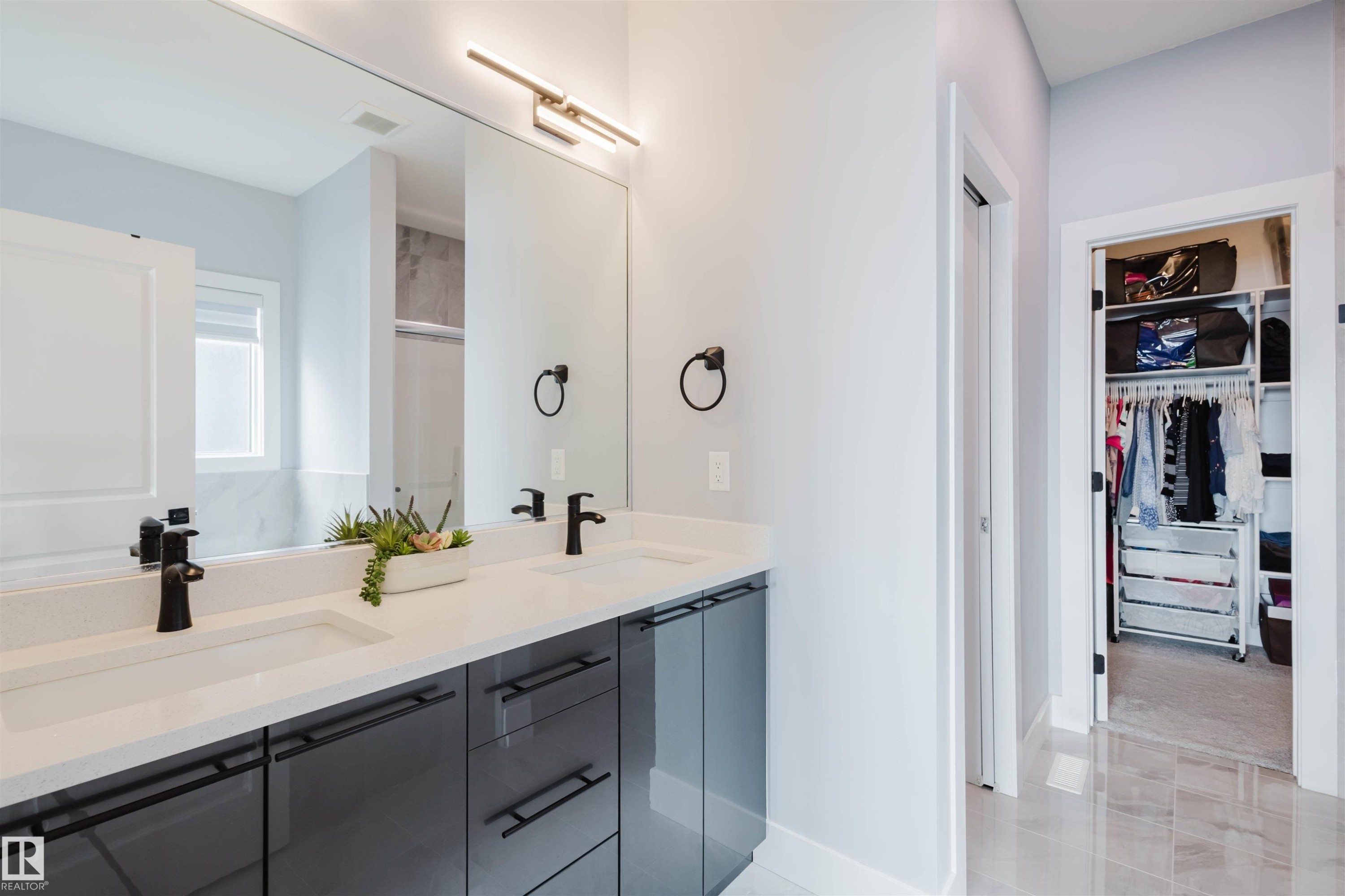 Bathroom featuring double vanity, a walk in closet, a stall shower, and light tile patterned flooring - 16217 32 Avenue, Edmonton, AB - Indoor Photo Showing Bathroom