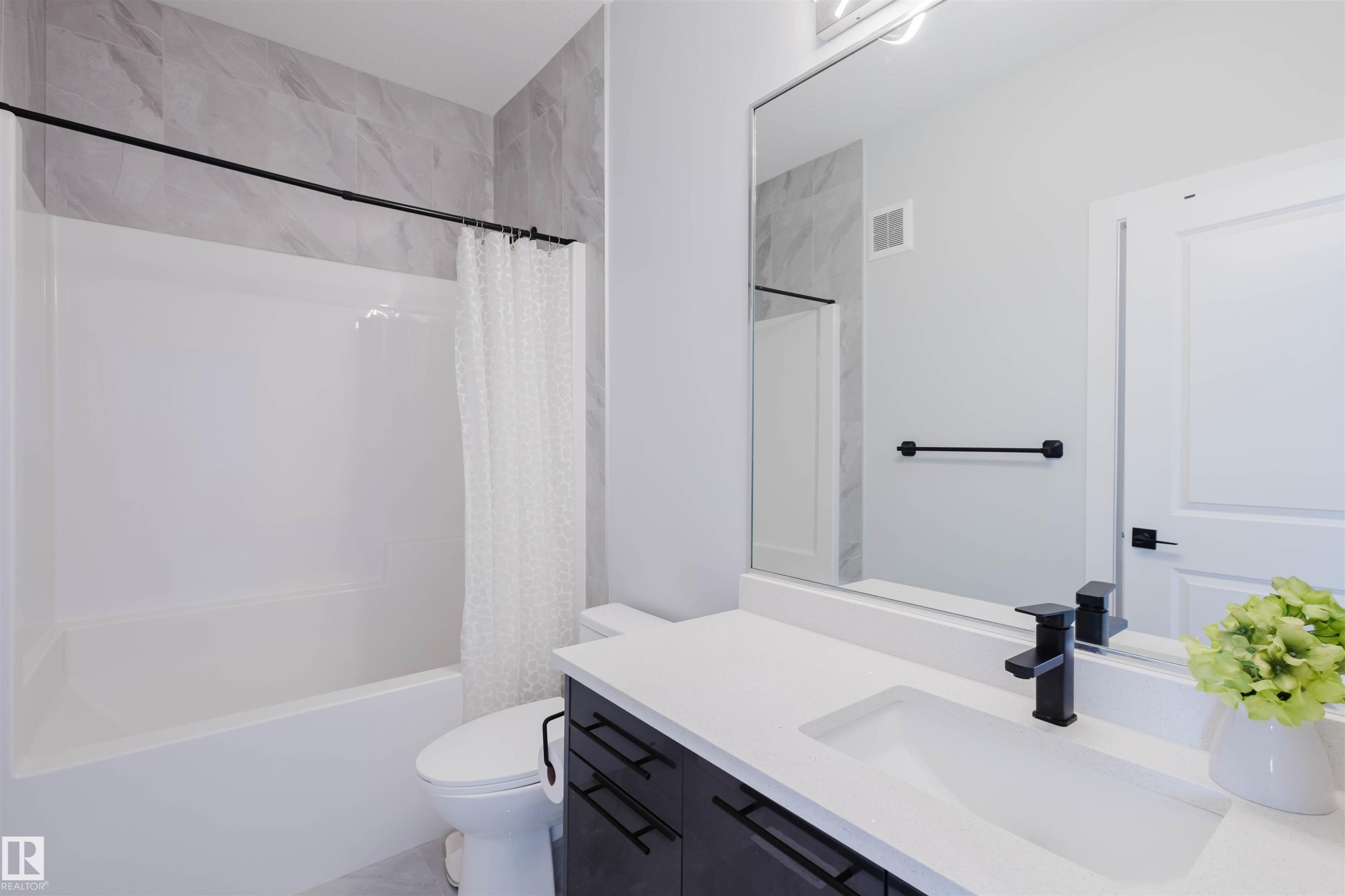 Bathroom featuring vanity and shower / bathtub combination with curtain - 16217 32 Avenue, Edmonton, AB - Indoor Photo Showing Bathroom