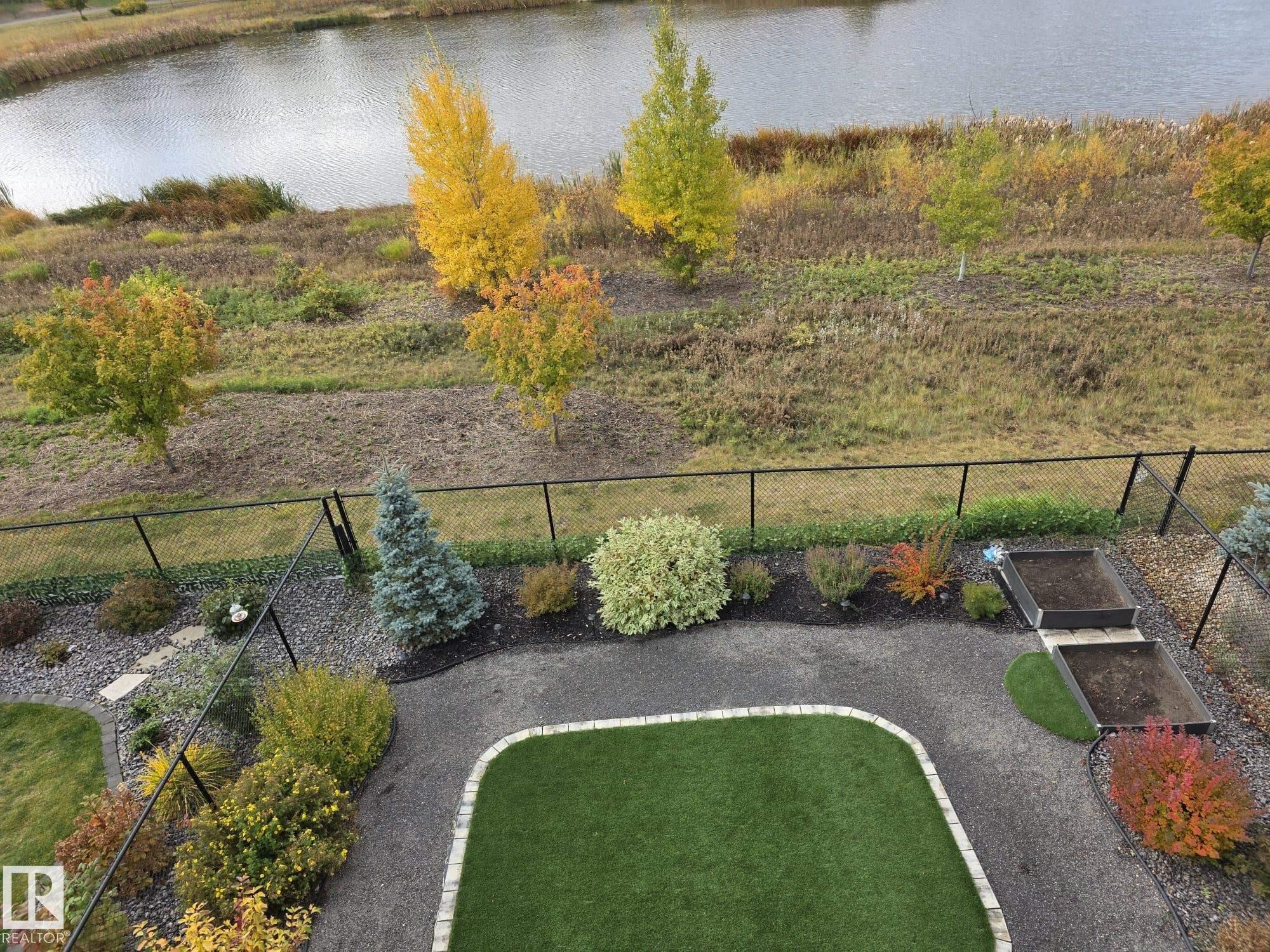 Fenced backyard with a water view - 16217 32 Avenue, Edmonton, AB - Outdoor With Body Of Water With View