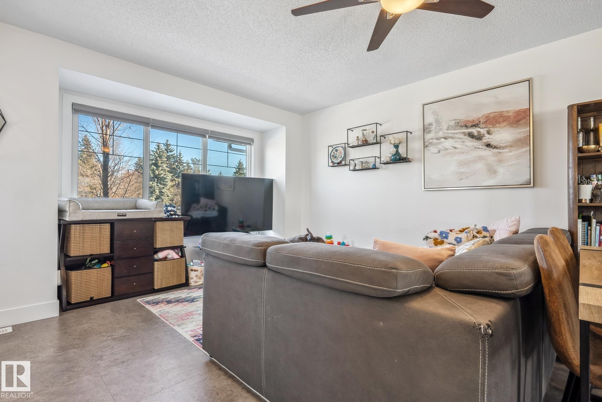 Living area with a textured ceiling and ceiling fan - 76 330 Bulyea Road, Edmonton, AB - Indoor