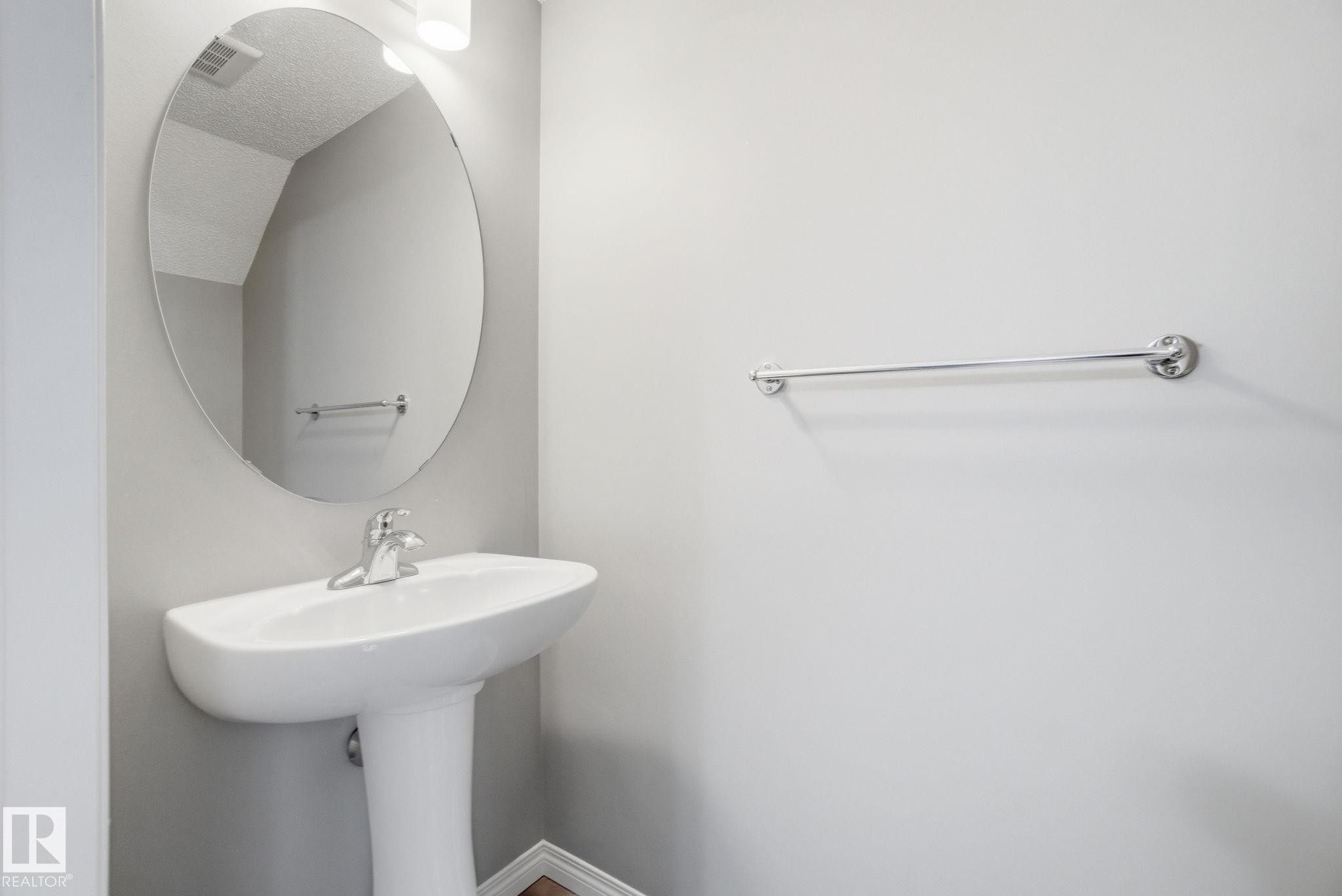 Bathroom featuring baseboards and a sink - 71 4029 Orchards Drive, Edmonton, AB - Indoor Photo Showing Bathroom