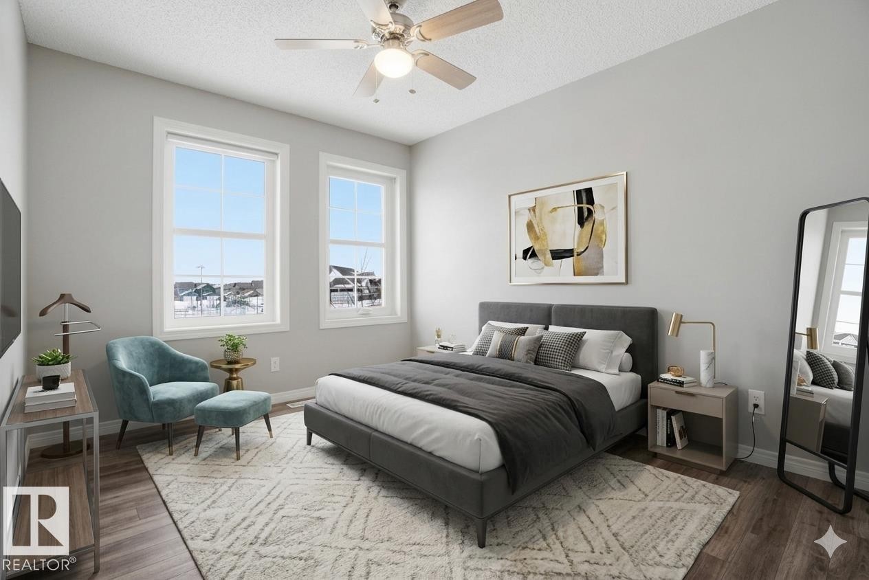 Bedroom with a ceiling fan, a textured ceiling, and dark wood-style flooring - 71 4029 Orchards Drive, Edmonton, AB - Indoor Photo Showing Bedroom